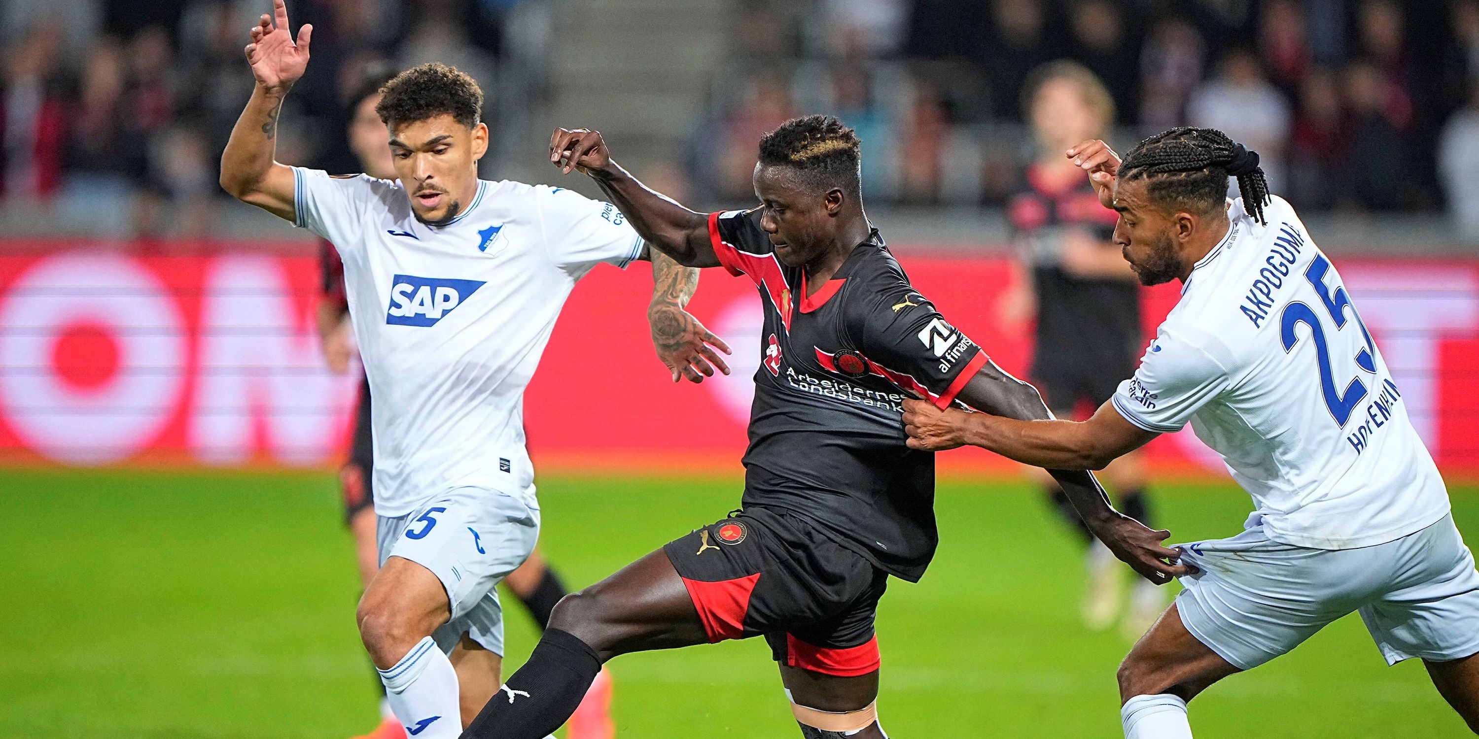 FC Midtjylland's Dju Franculino in action with TSG 1899 Hoffenheim's Valentin Gendrey and Kevin Akpoguma Bo Amstrup