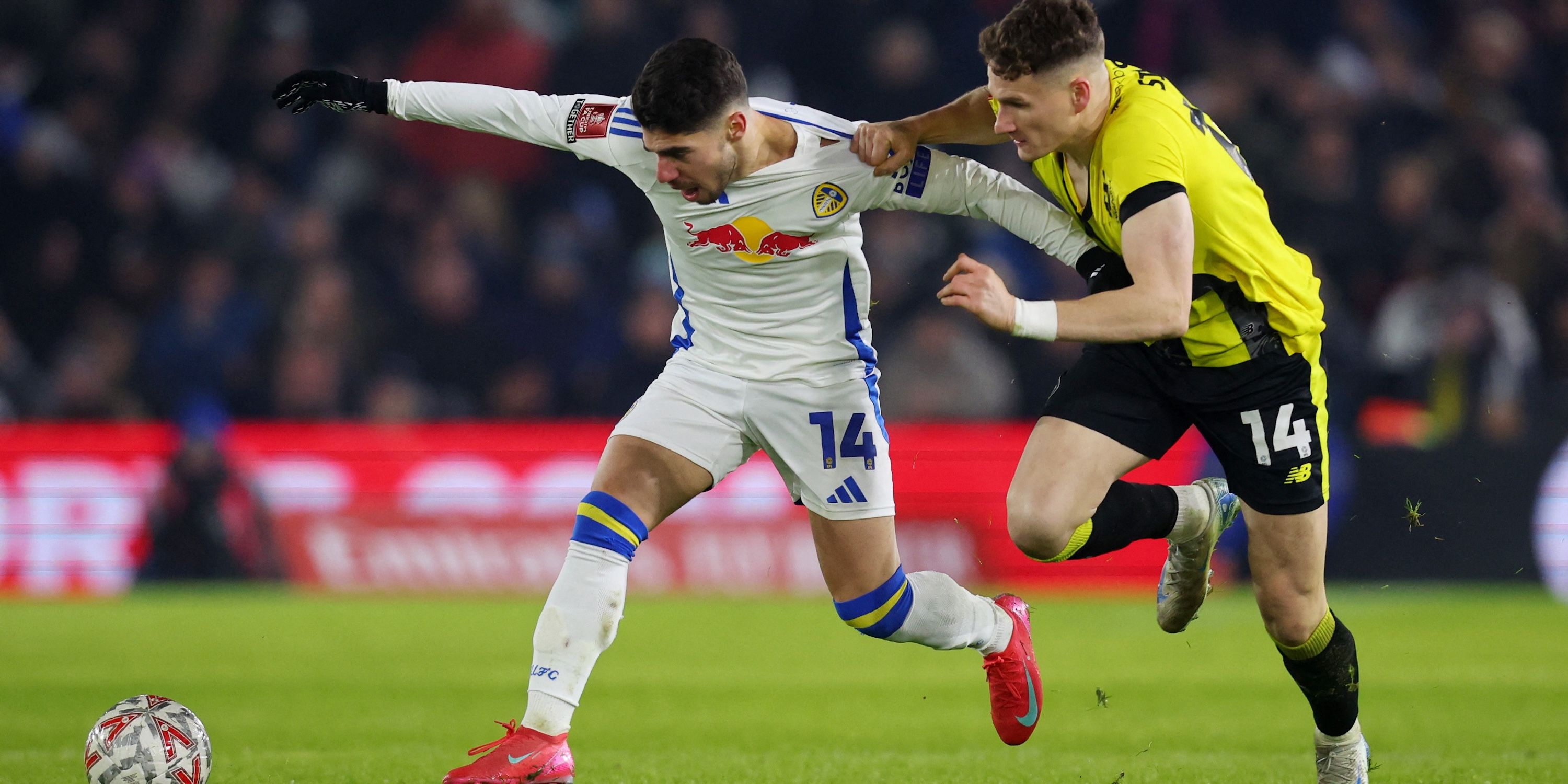 Leeds United's Manor Solomon in action with Harrogate Town's Toby Sims