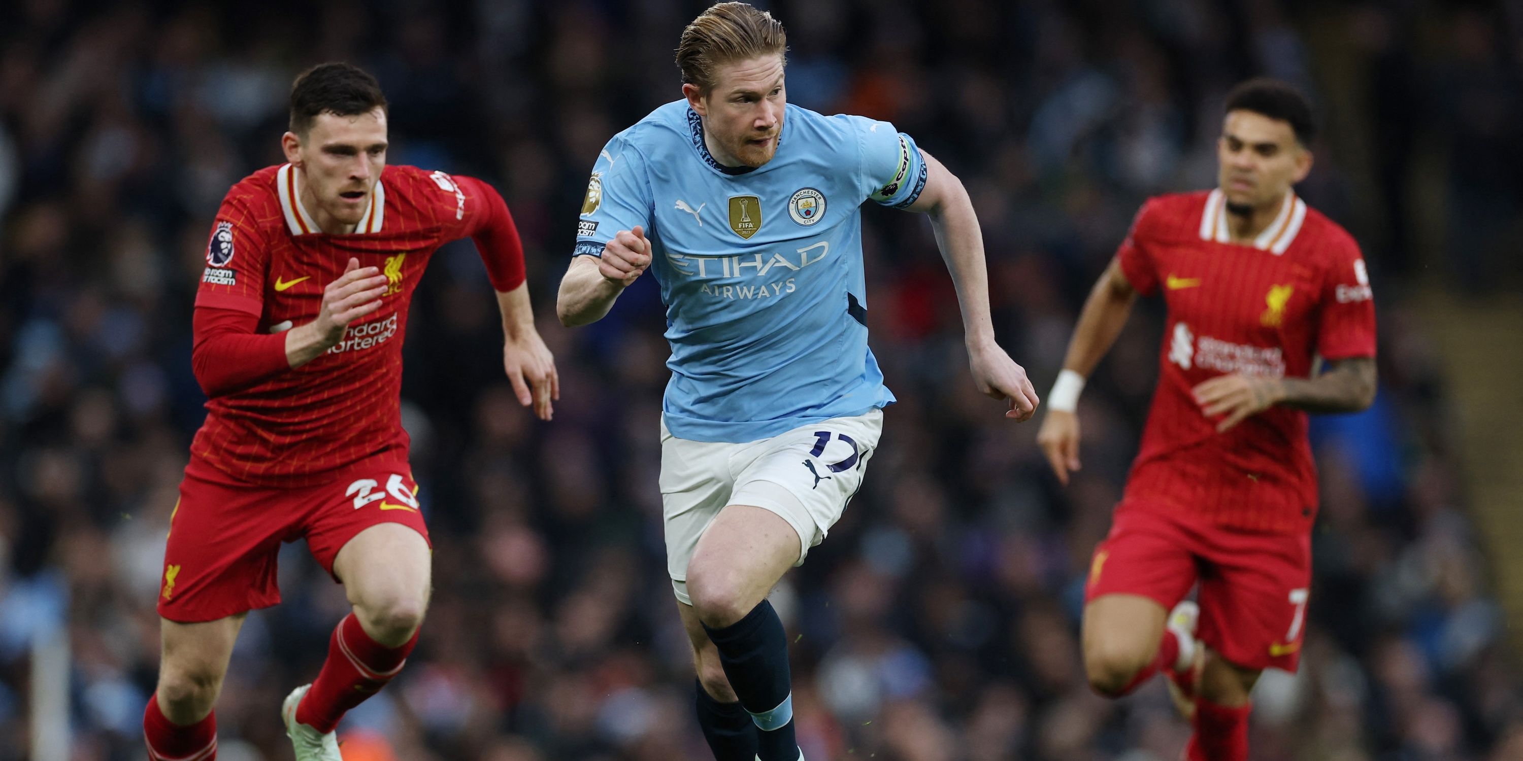 Manchester City's Kevin De Bruyne in action with Liverpool's Andrew Robertson