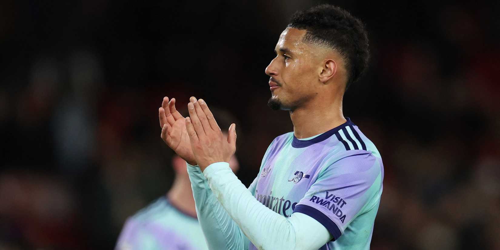 Arsenal's William Saliba applauds fans after the match