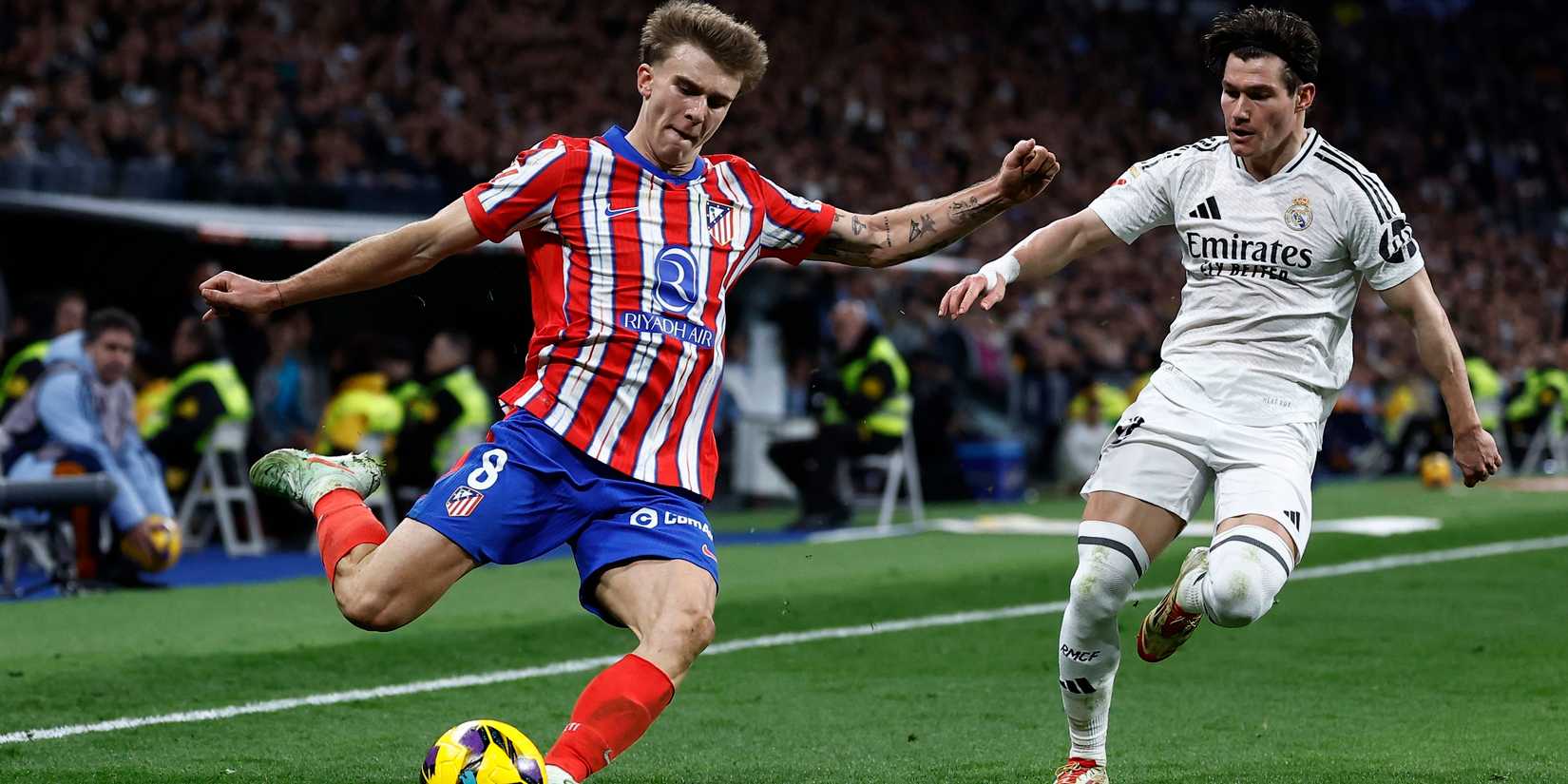 Atletico Madrid's Pablo Barrios in action with Real Madrid's Fran Garcia