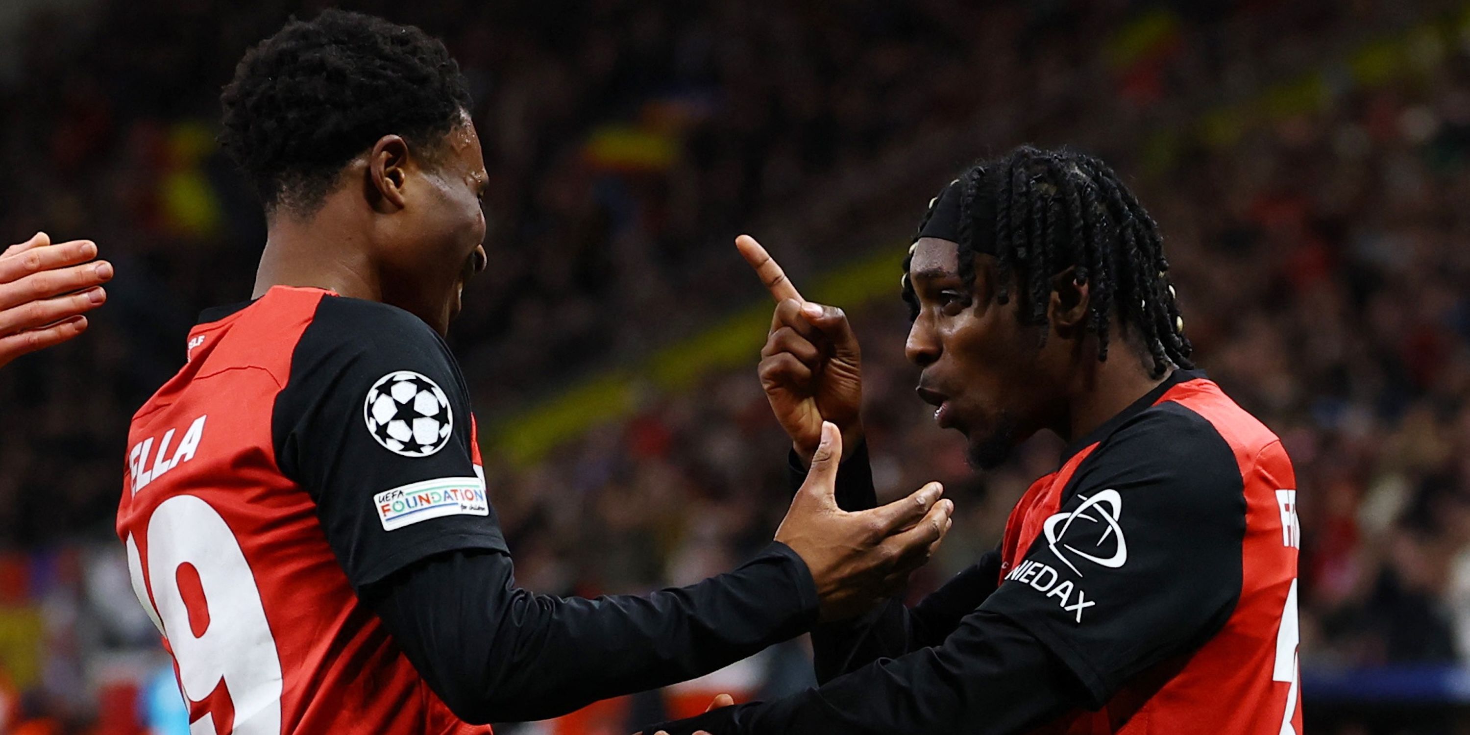 Bayer Leverkusen's Nathan Tella celebrates scoring their second goal with Jeremie Frimpong 