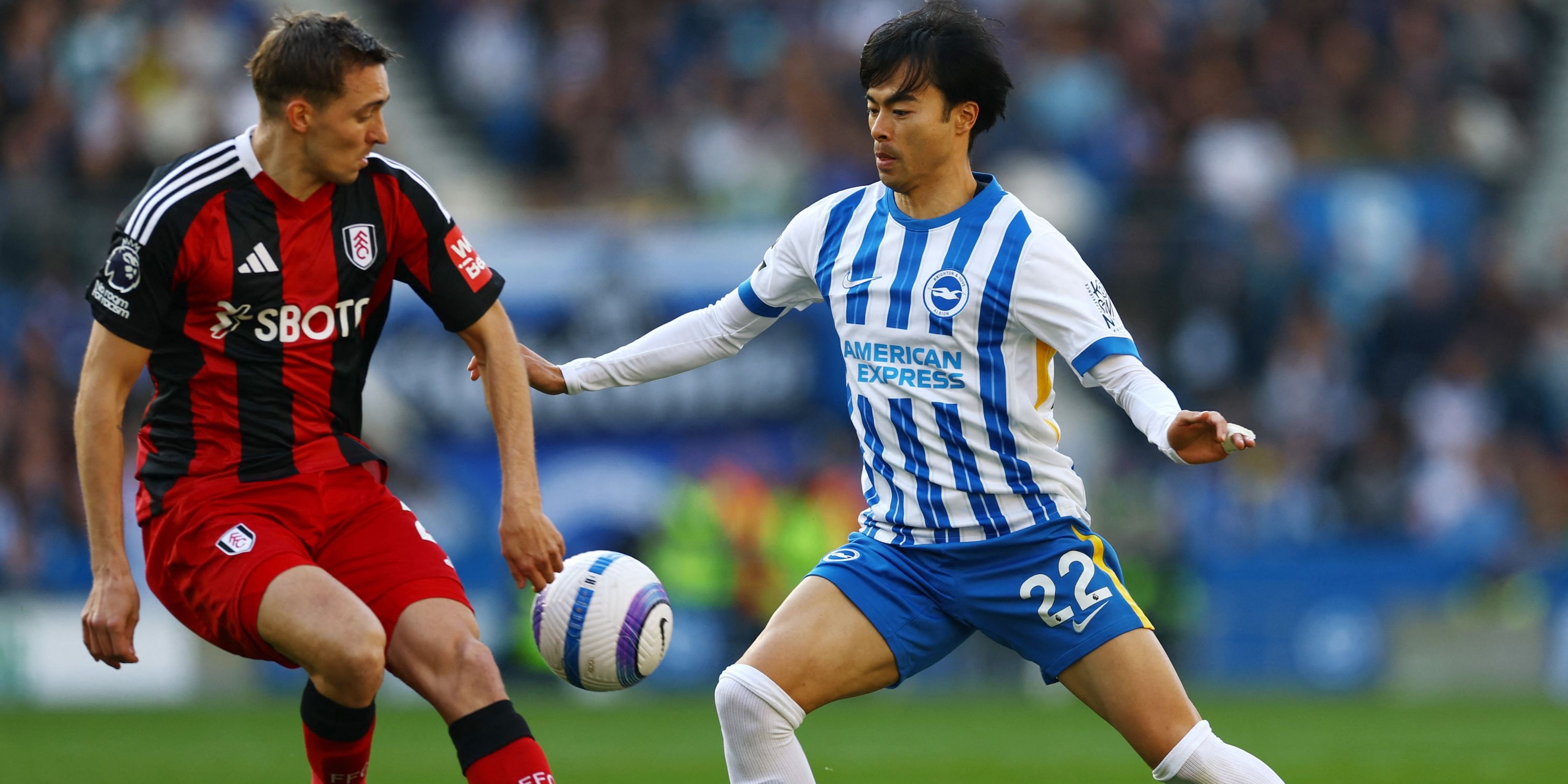 Kaoru Mitoma in action by Brighton & Hove Albion with Timothy Castagne de Fulham