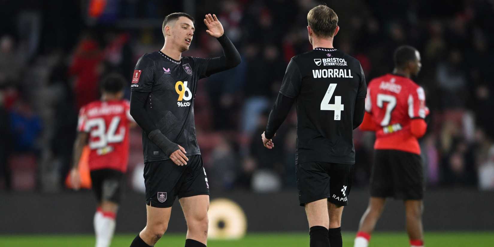Burnley's Joe Worrall and Burnley's Maxime Esteve celebrate after the match