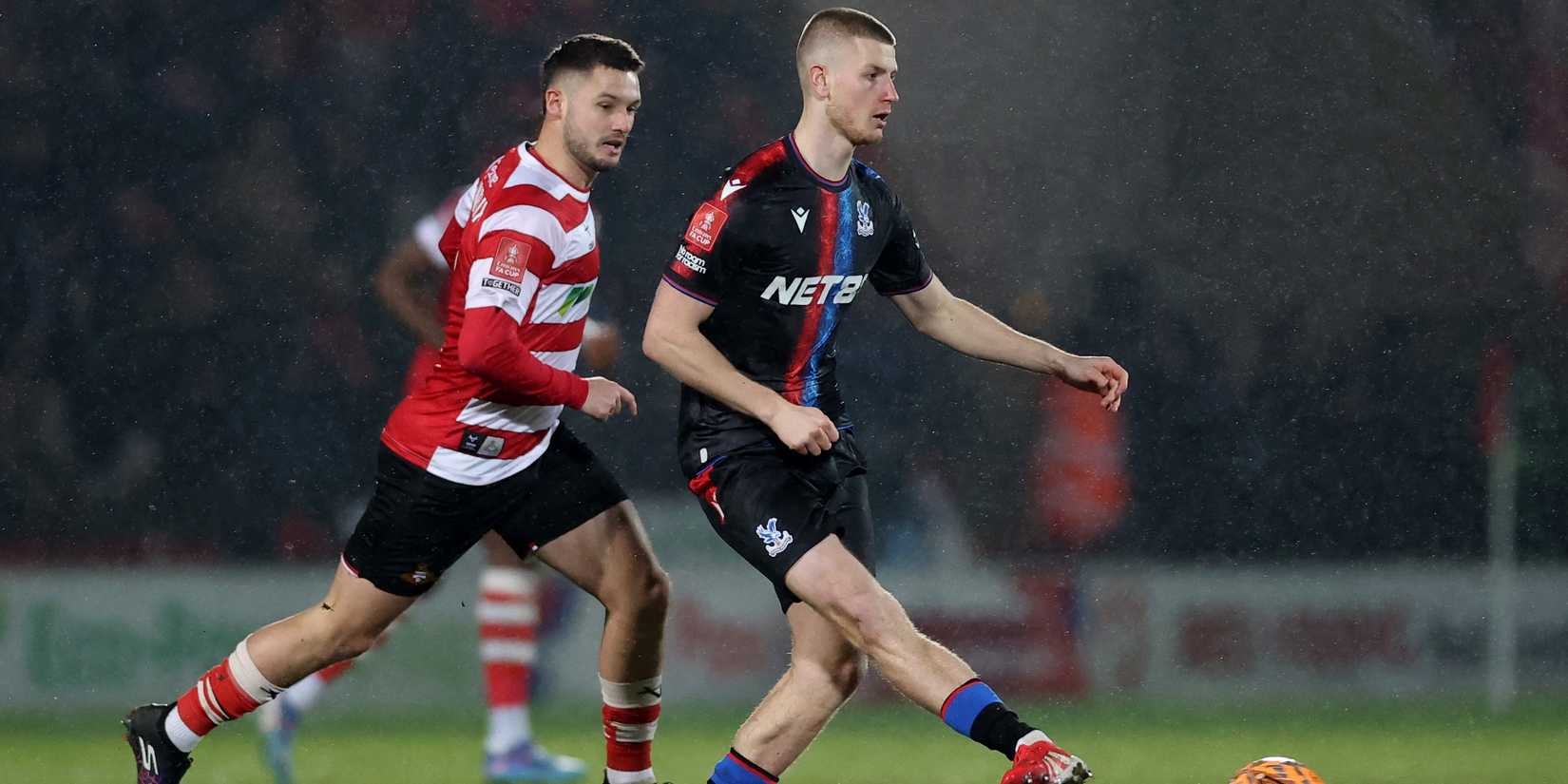Doncaster Rovers' Luke Moileux at work with Adam Wharton from Crystal Palace