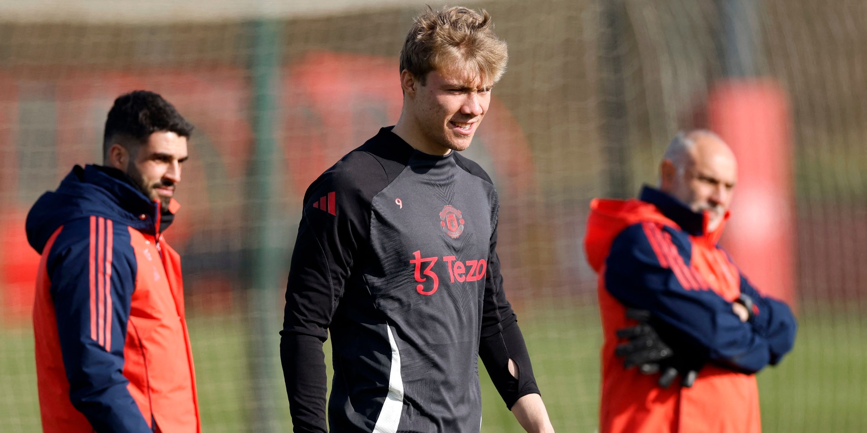 Manchester United's Rasmus Hojlund with assistant head coach Carlos Fernandes during training