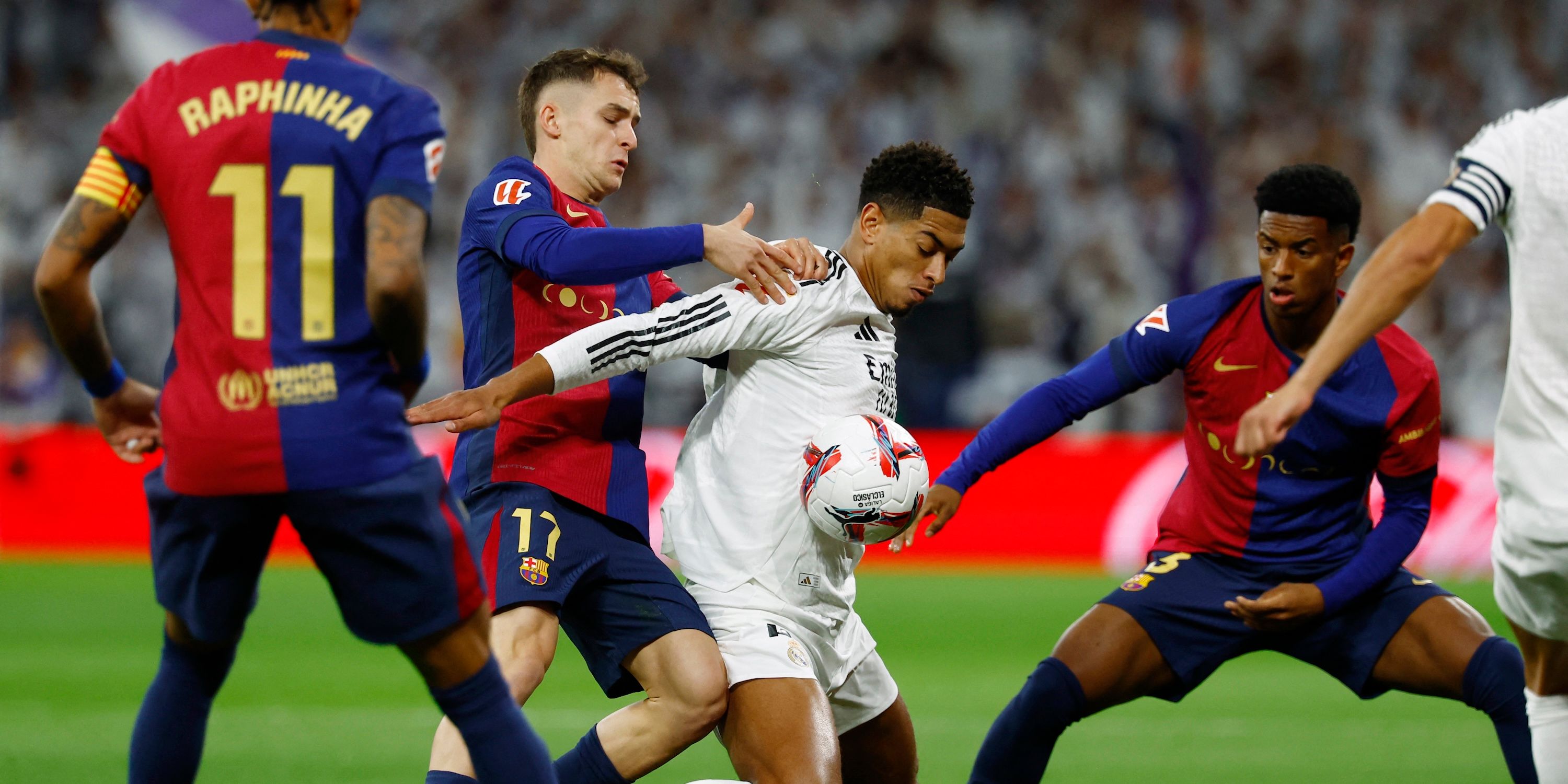 Real Madrid's Jude Bellingham in action with FC Barcelona's Marc Casado