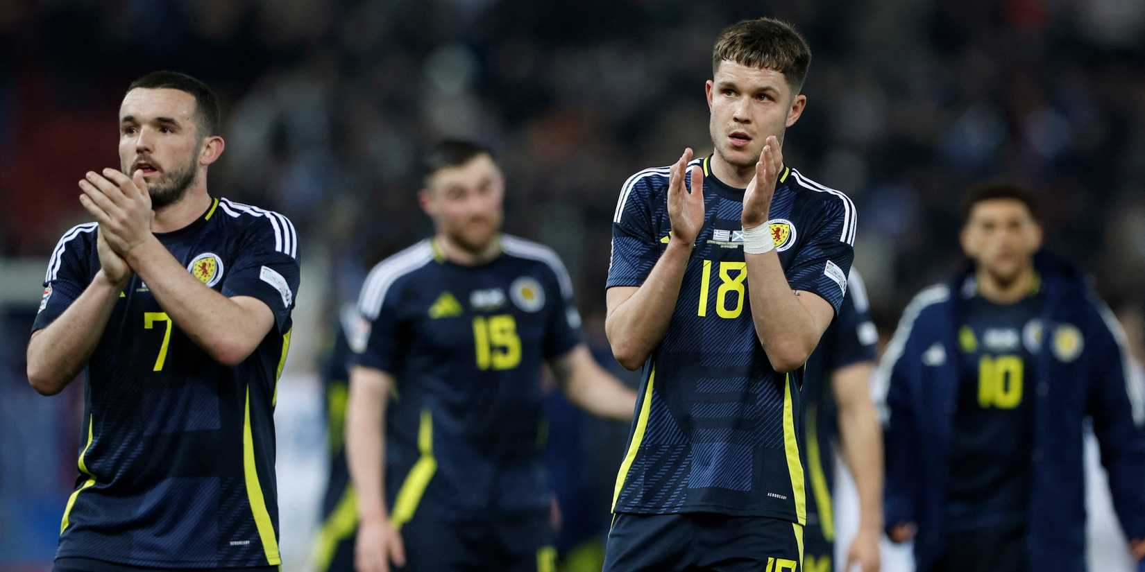 Scots George Hirst and John McGinn applaud the fans after the match
