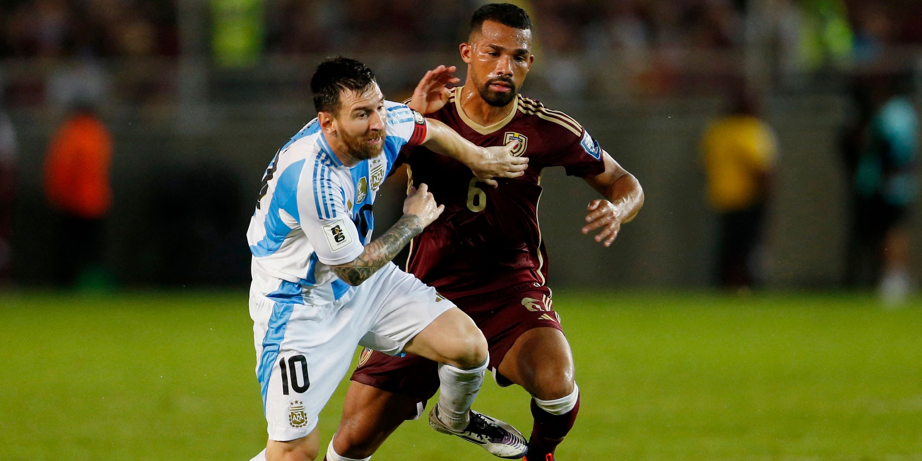 Lionel Messi of Argentina acts with Yangel Herrera of Venezuel