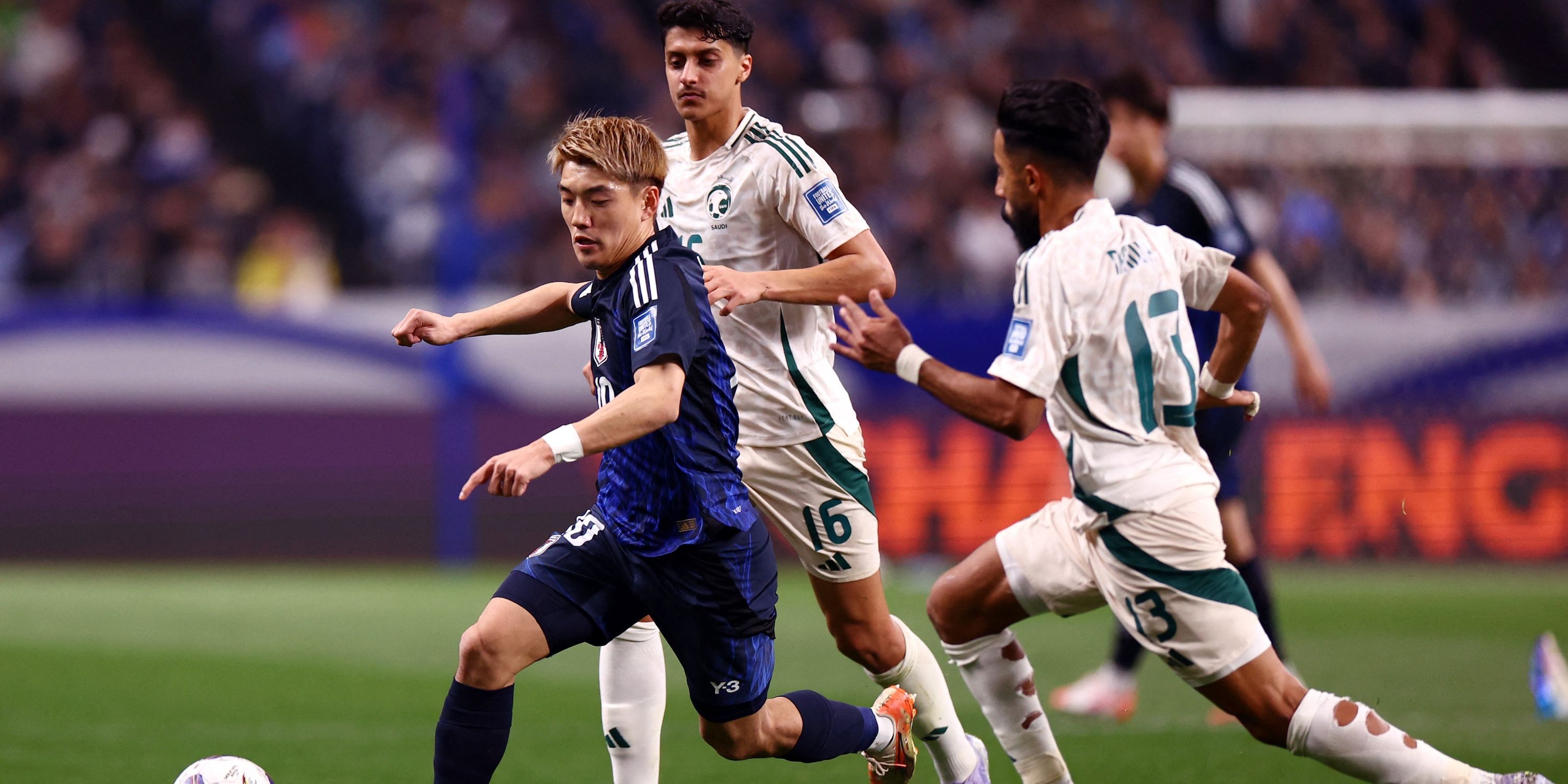 Ritsu Doan, Japan, is moving with Saudi Arabia Nawaf Boushal and Faisel Al-Qhamdi