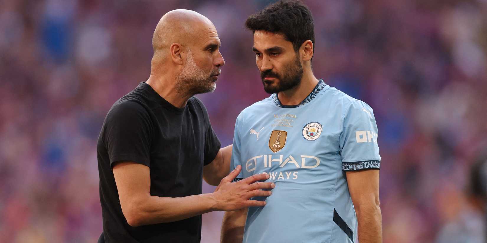 Manchester City's Ilkay Gundogan and manager Pep Guardiola