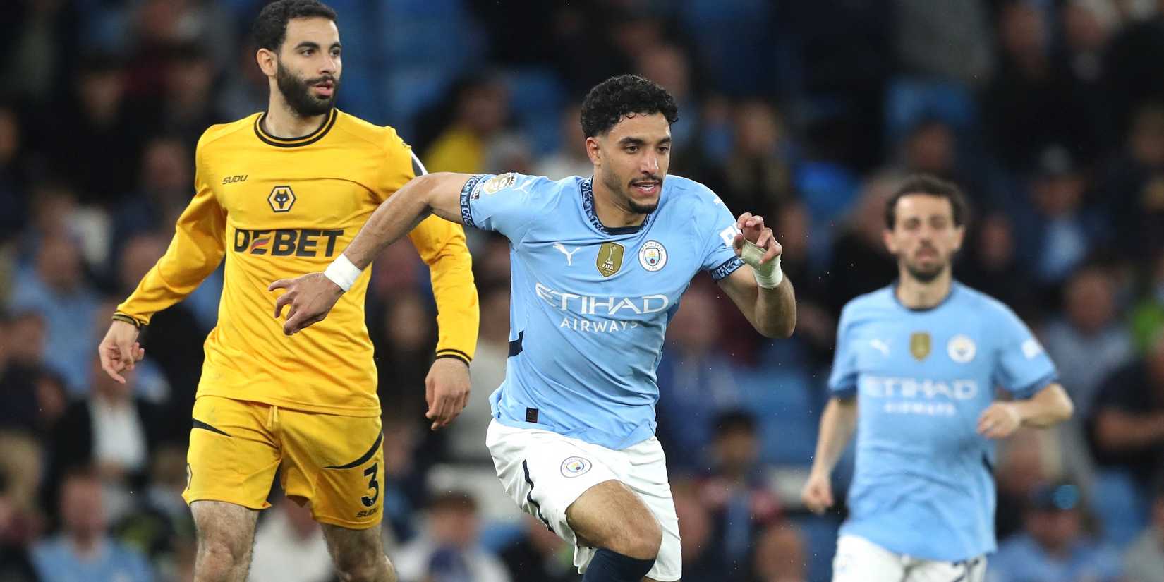 Manchester City's Omar Marmoush in action with Wolverhampton Wanderers' Rayan Ait-Nouri