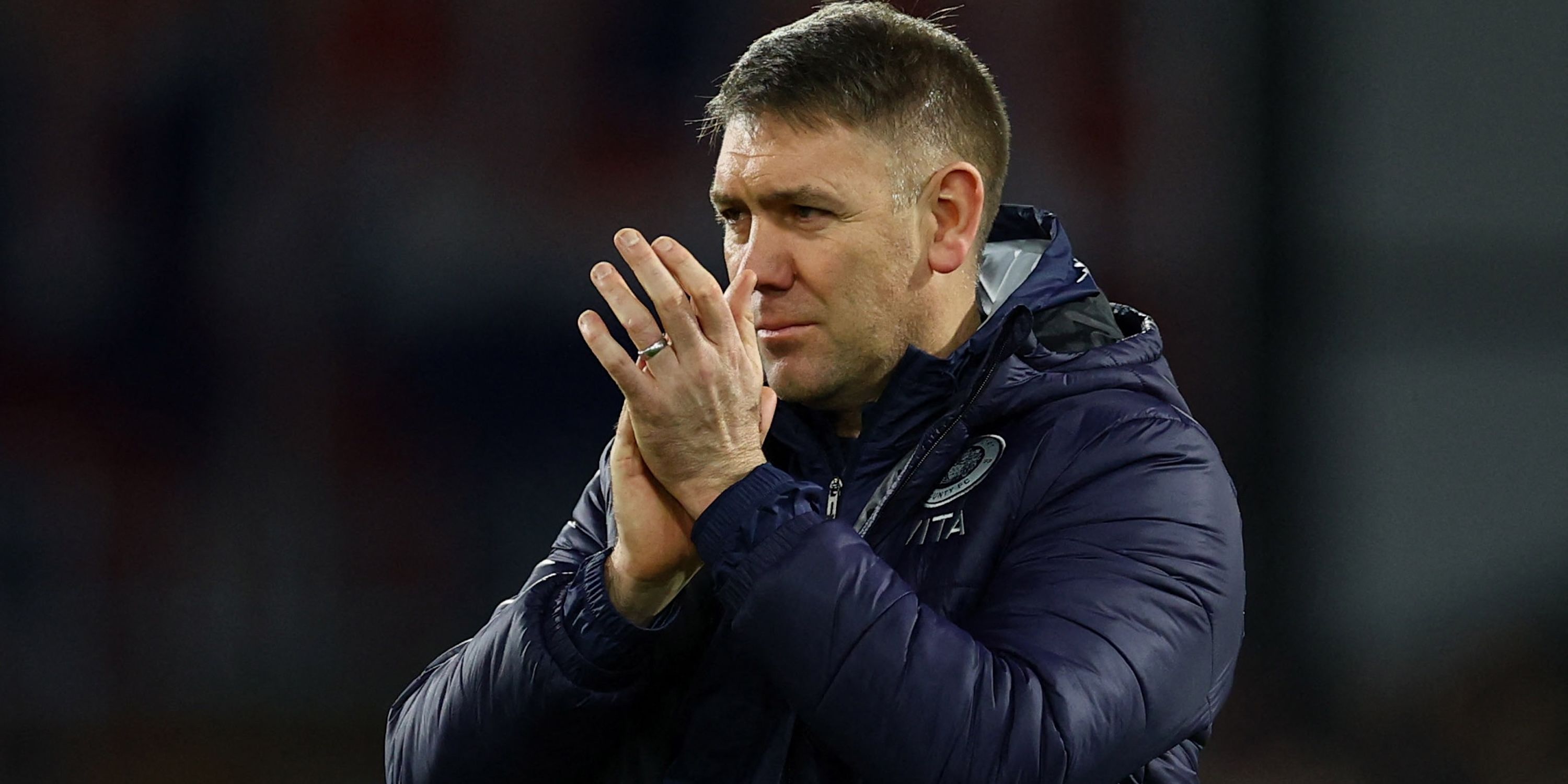 Stockport County manager Dave Challinor applauds fans after the match