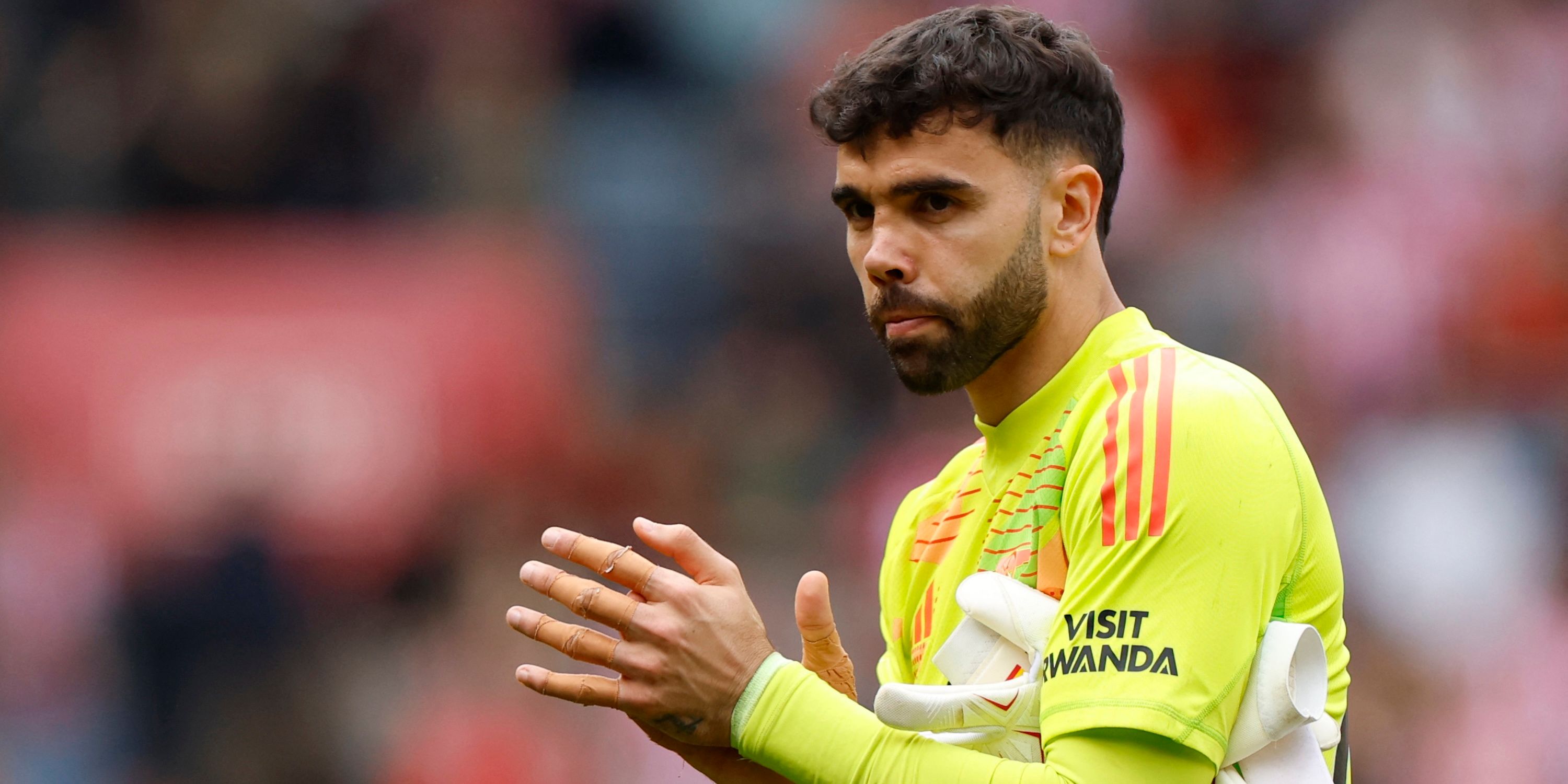 Arsenal's David Raya applauds fans after the match