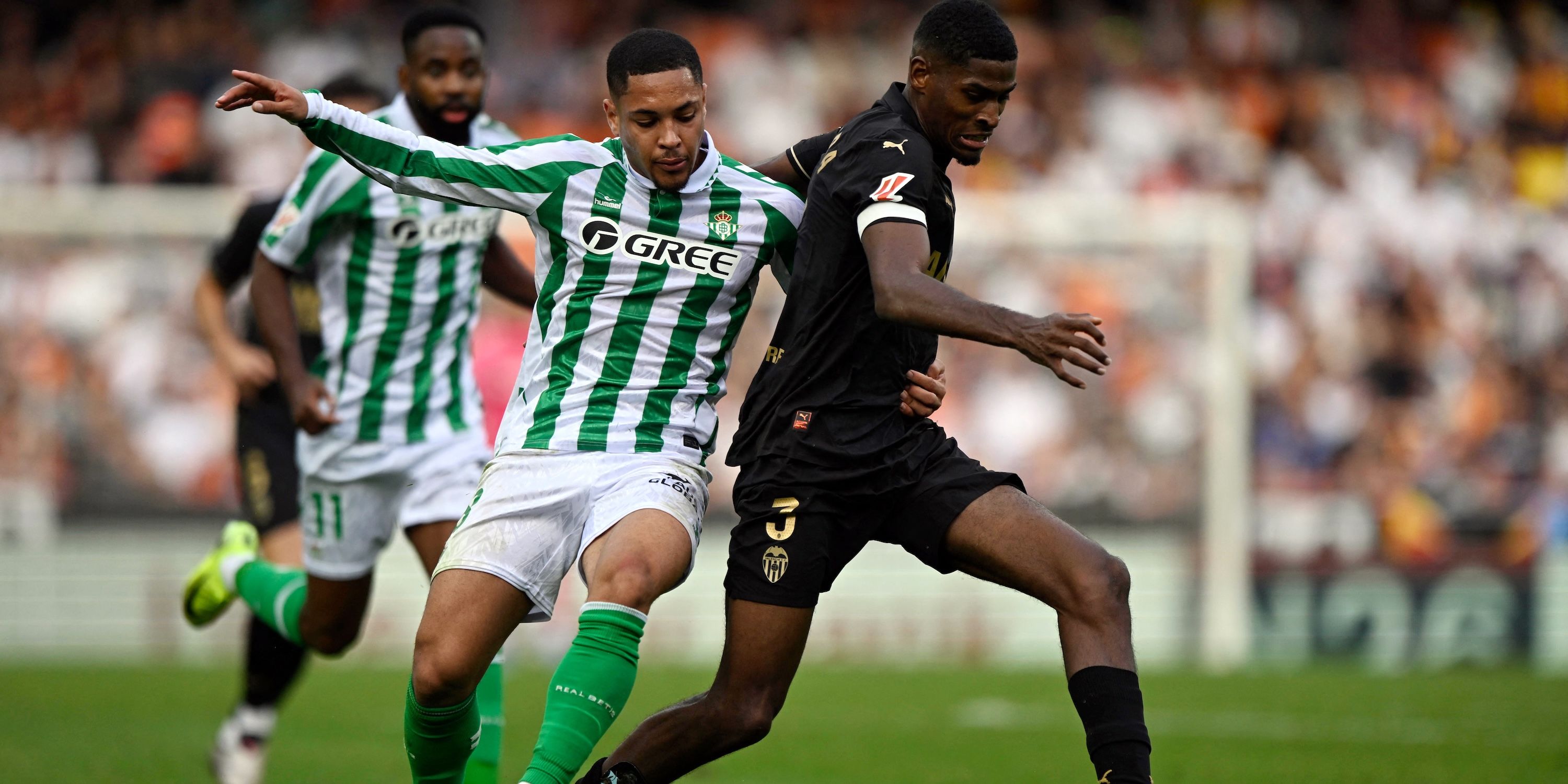Real Betis' Vitor Roque in action with Valencia's Cristhian Mosquera