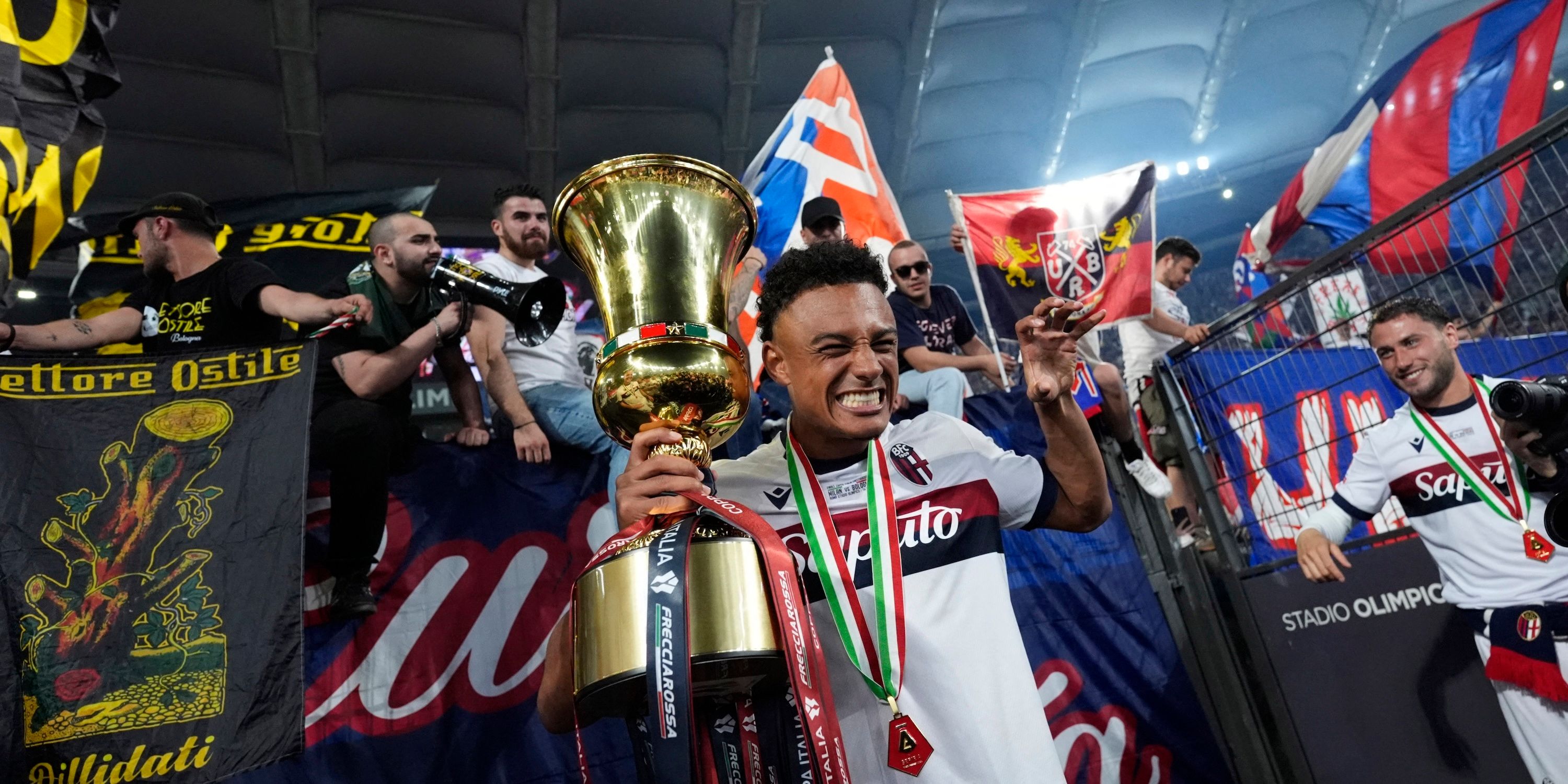 Bologna's Dan Ndoye celebrates with the trophy after winning the Coppa Italia