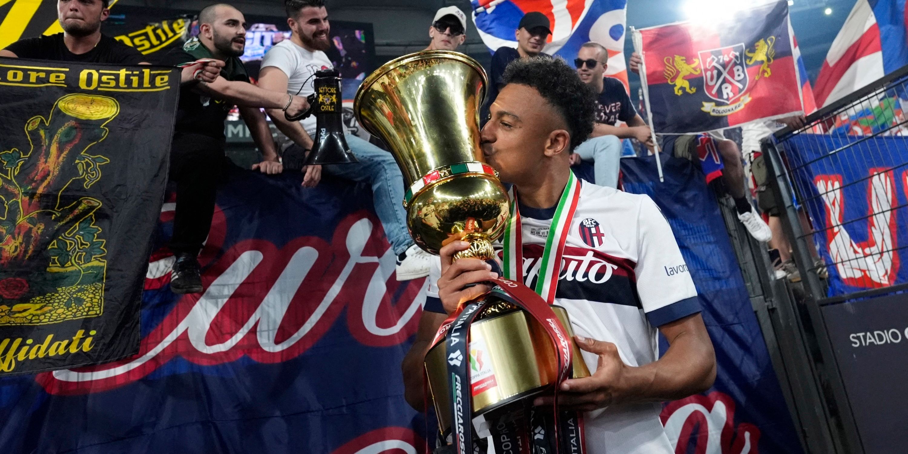 DAN NDOYE accepts Bologna the cup and celebrates after winning Coppa Italia