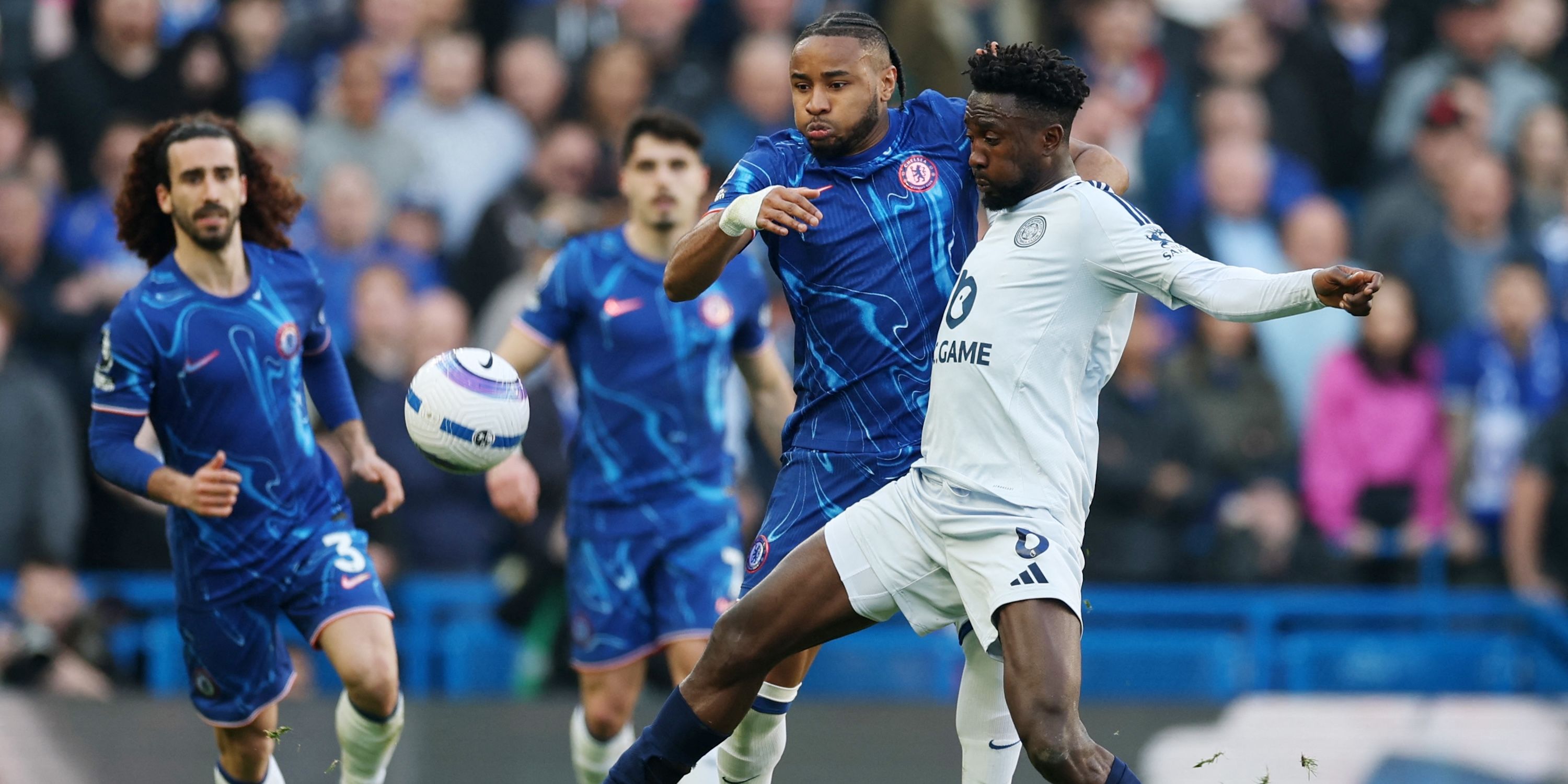 Christopher Nkunku of Chelsea in action with Wilfred Ndidi of Leicester City