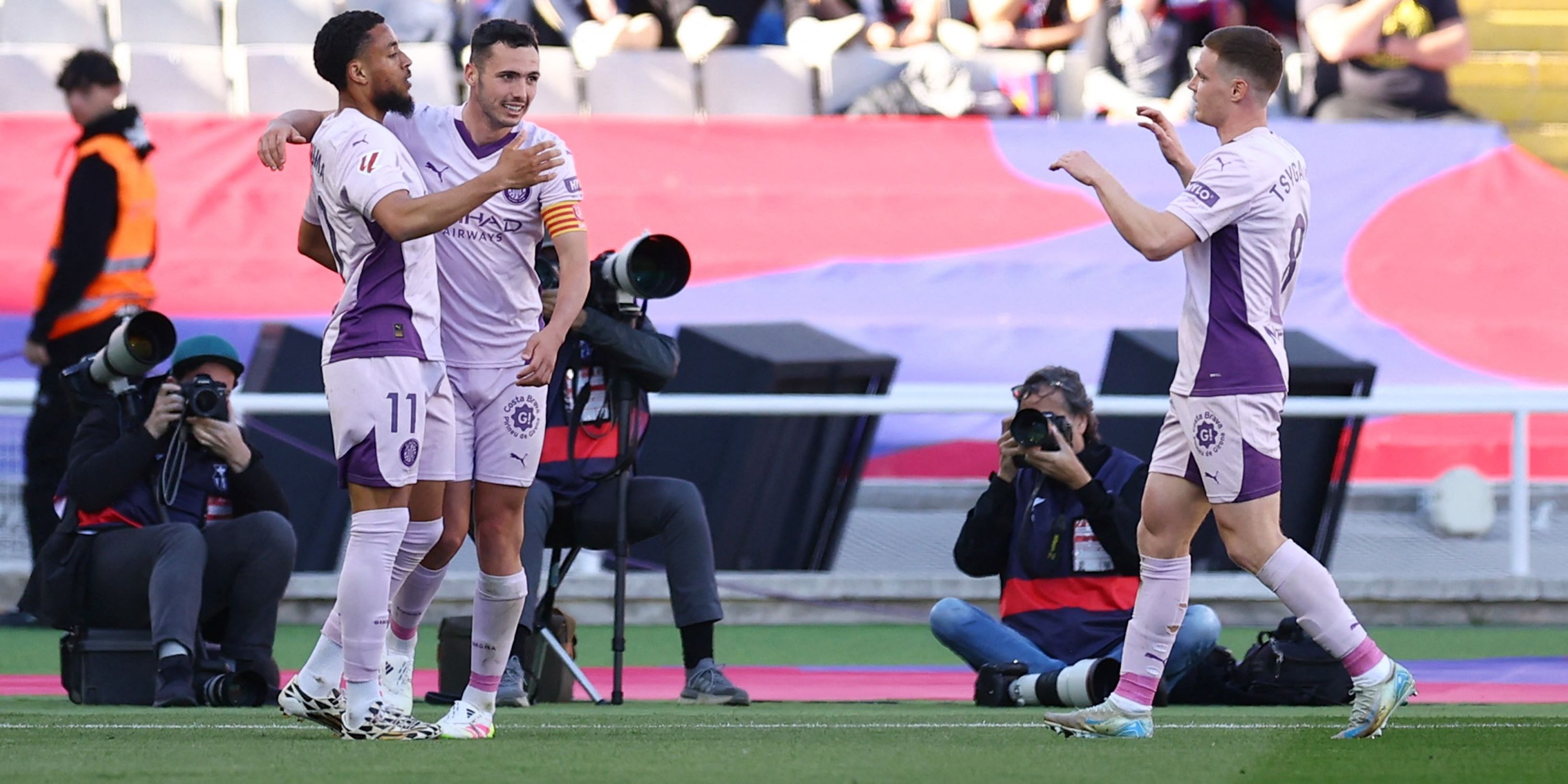 Girona's Arnaut Danjuma celebrates with Arnau Martinez and Viktor Tsyhankov after scoring their first goal