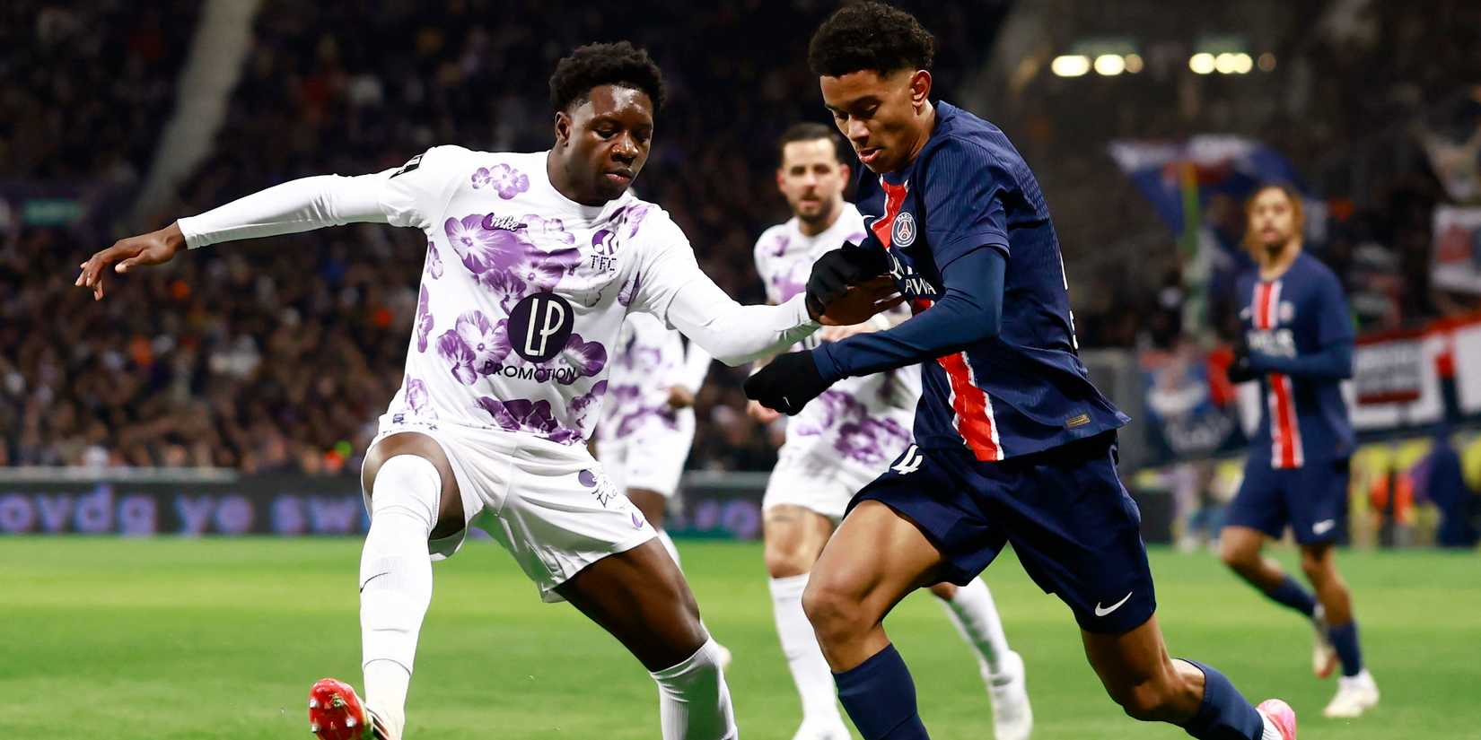 Toulouse's Jaydee Canvot in action with Paris St Germain's Senny Mayulu 
