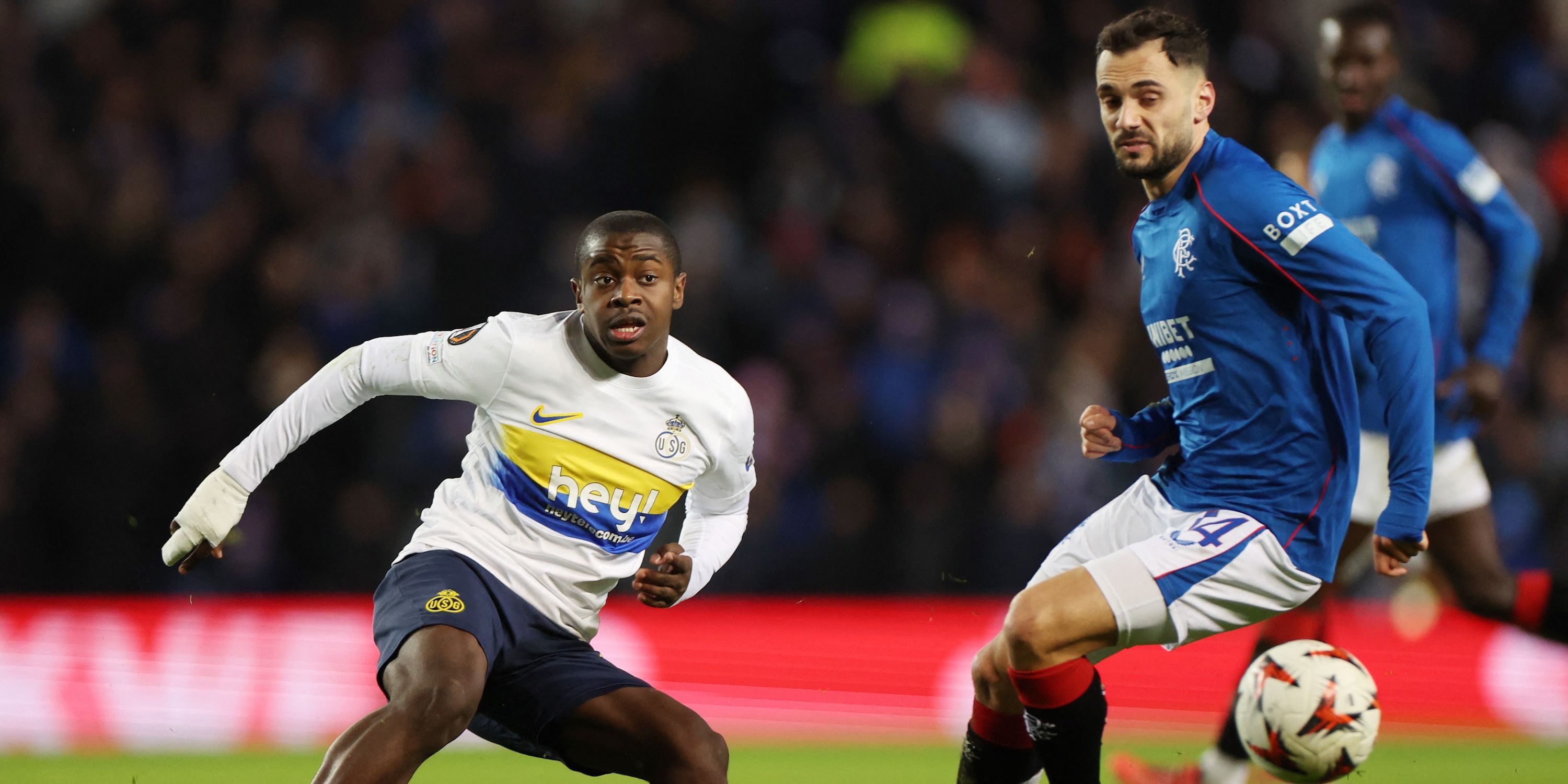 Unity Saint-Gilloise's Need Sadiki, Rangers' in action with Nedim Bajrami