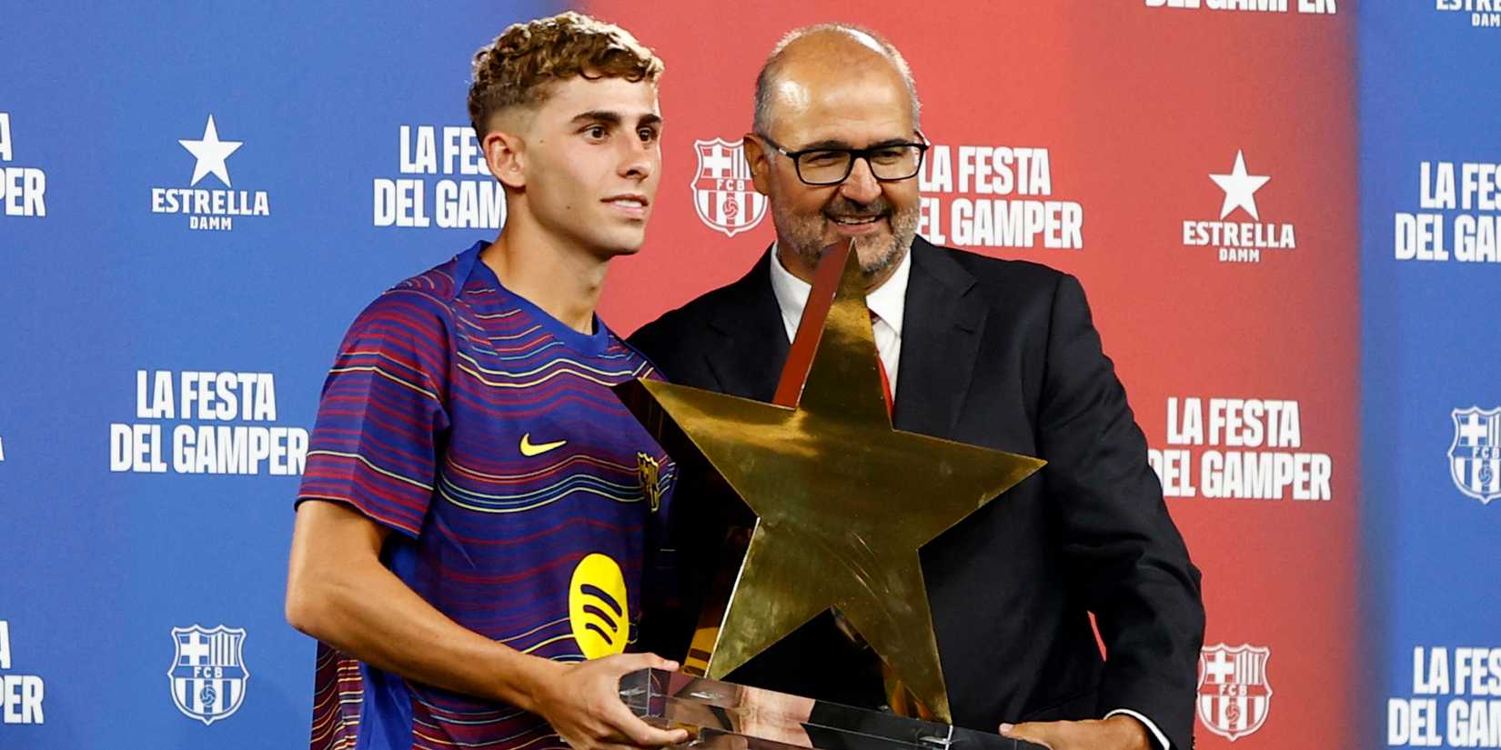 FC Barcelona's Fermin Lopez is presented with the MVP trophy after the match