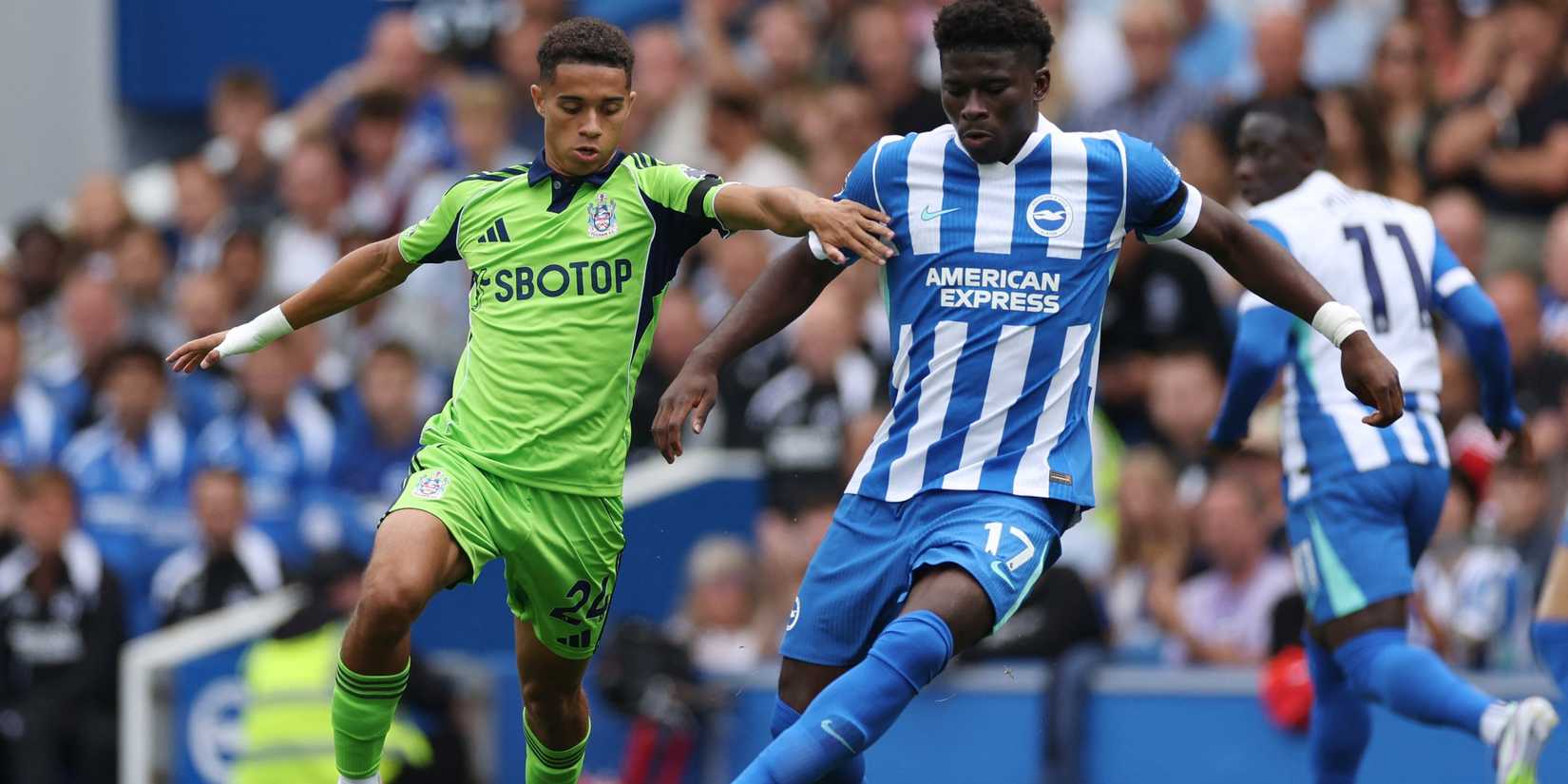 Fulham's Josh King in action with Brighton & Hove Albion's Carlos Baleba