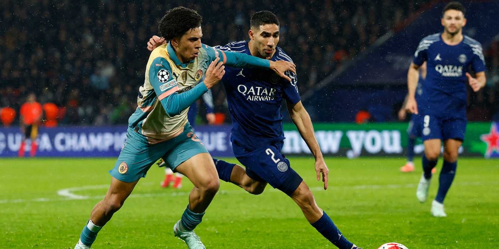 Rico Lewis in action by Manchester City with Achraf Hakimi from Paris St Germain 