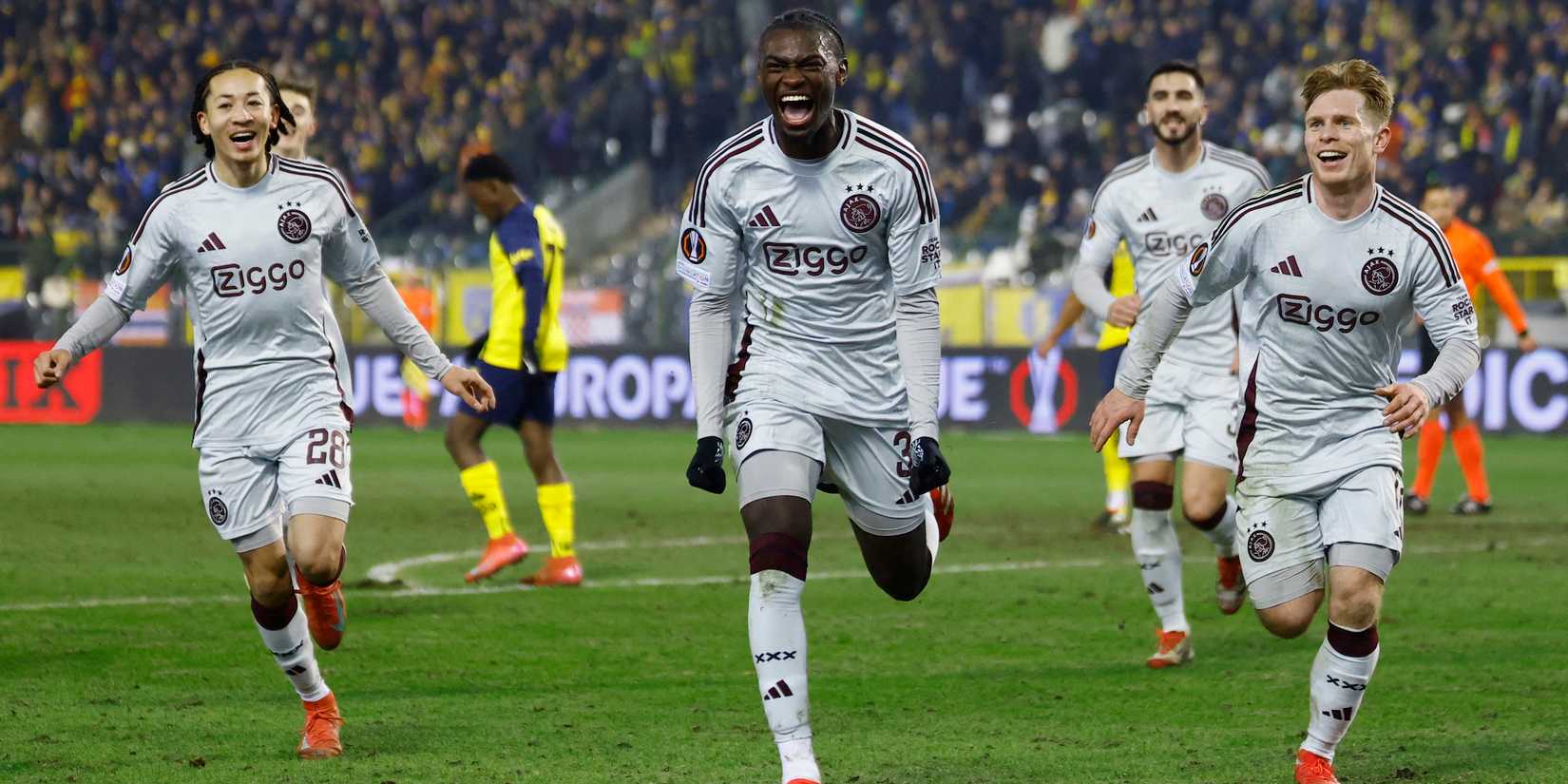 Ajax Amsterdam's Jorthy Mokio celebrates scoring their second goal with Oliver Valaker Edvardsen and Kian Fitz-Jim