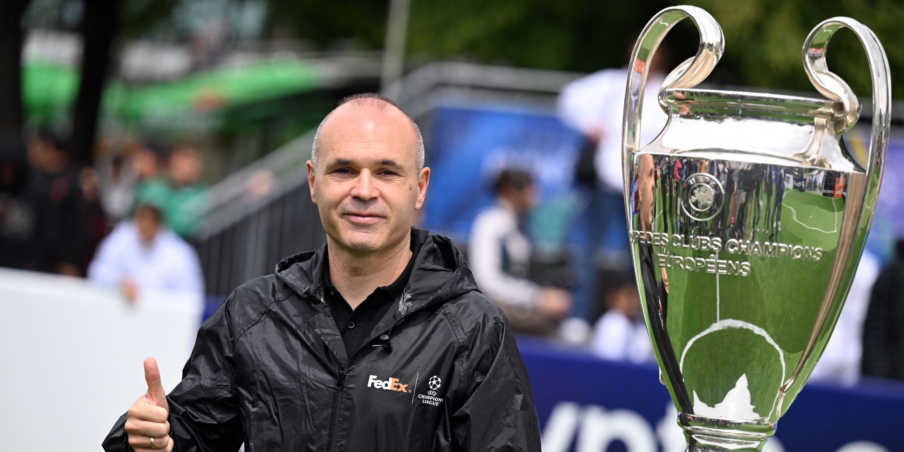 Former FC Barcelona player Andres Iniesta poses with the Champion League trophy ahead of the final