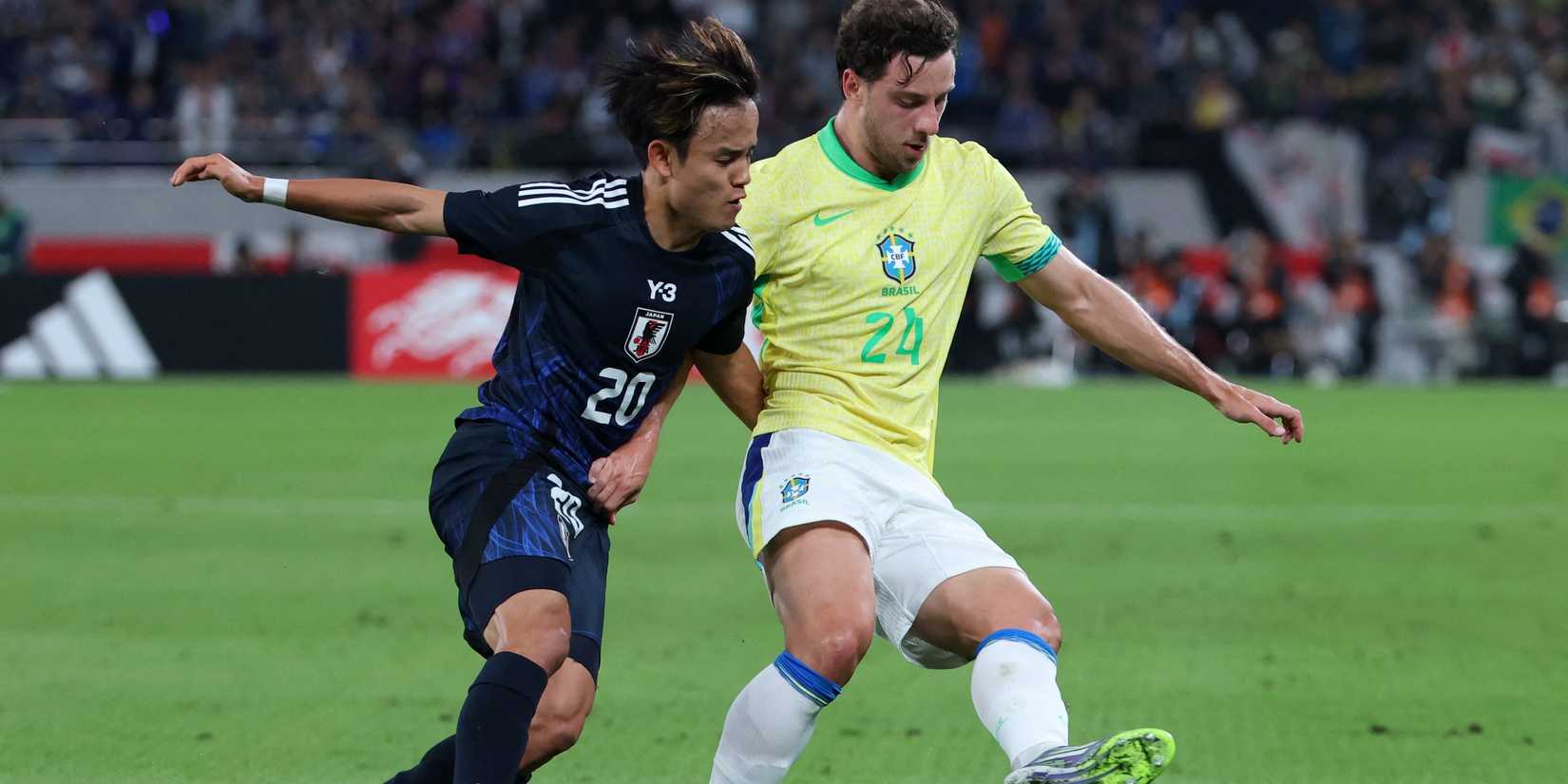 Brazil's Carlos Augusto in action with Japan's Takefusa Kubo