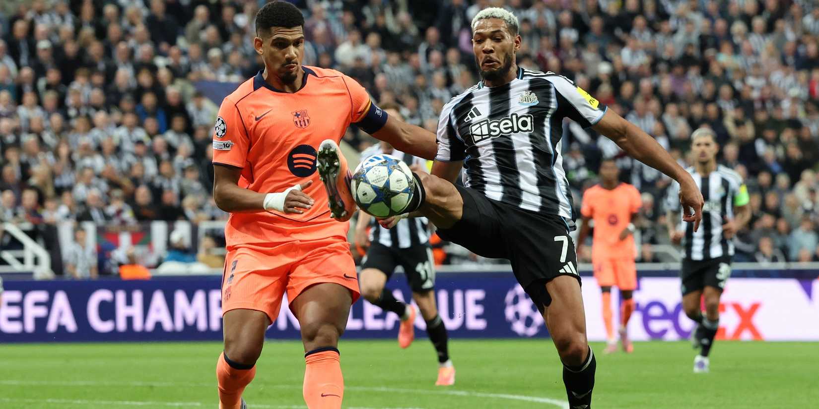 FC Barcelona's Ronald Araujo in action with Newcastle United's Joelinton
