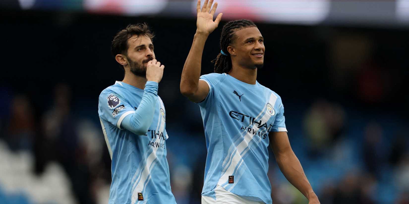 Manchester City's Bernardo Silva and Nathan Ake celebrate after the match 