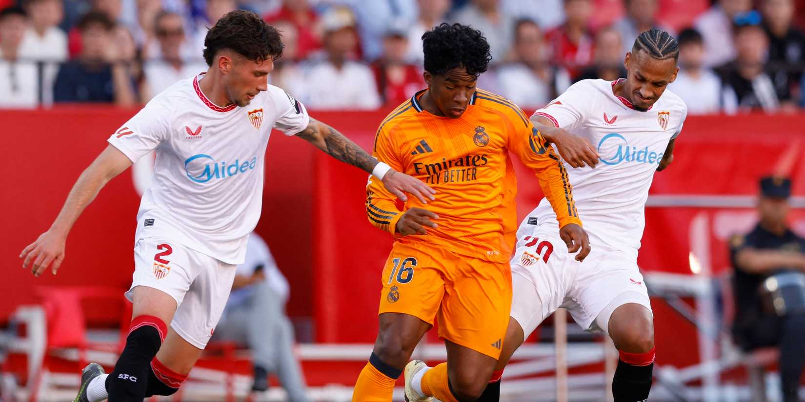 Real Madrid's Endrick in action with Sevilla's Jose Angel Carmona and Sevilla's Djibril Sow