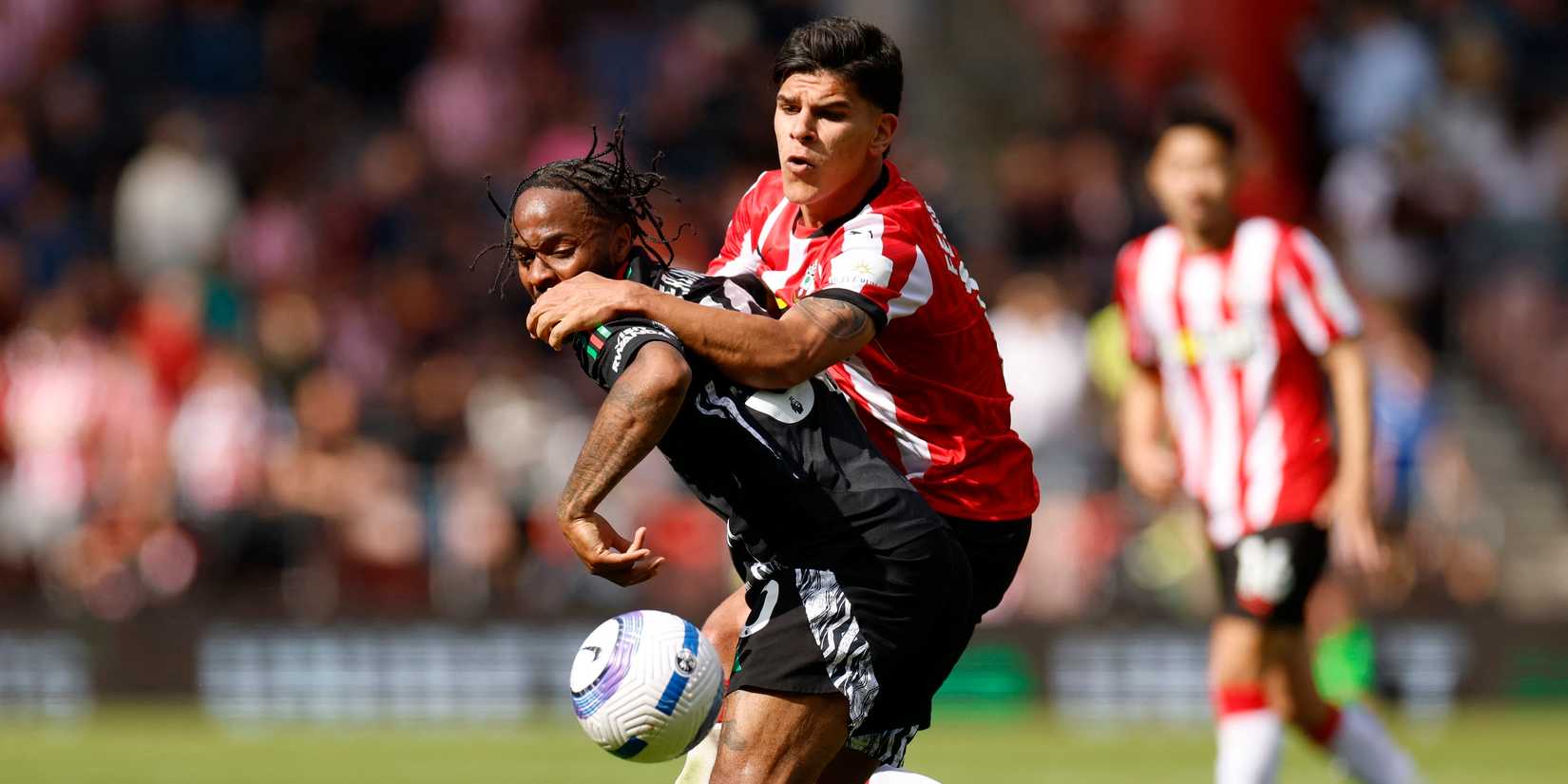 Arsenal's Raheem Sterling vs. Southampton's Mateusz Fernandez during the match