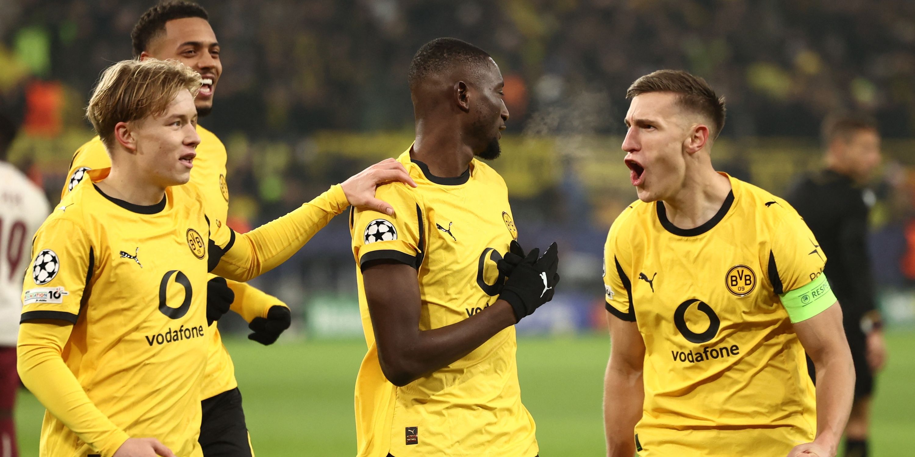 Borussia Dortmund's Serhou Guirassy celebrates scoring their second goal with Borussia Dortmund's Daniel Svensson and Borussia Dortmund's Nico Schlotterbeck