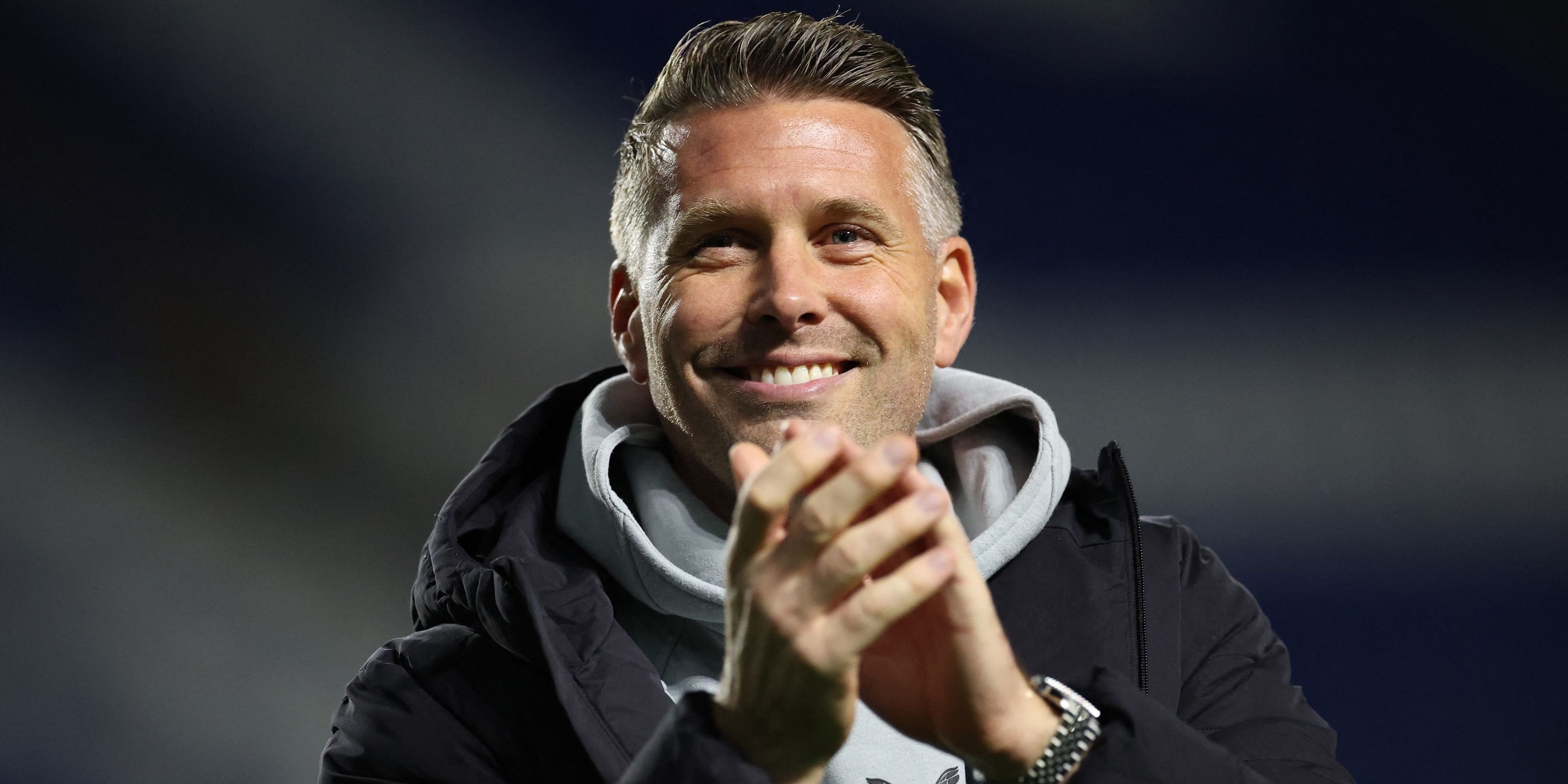 Rob Edwards applauds fans after the match