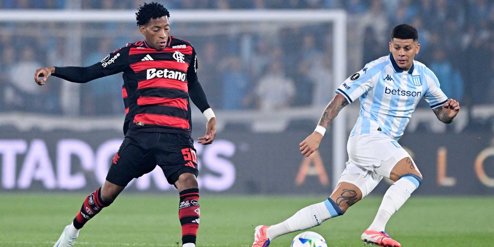 Racing Club's Marcos Rojo in action with Flamengo's Gonzalo Plata 