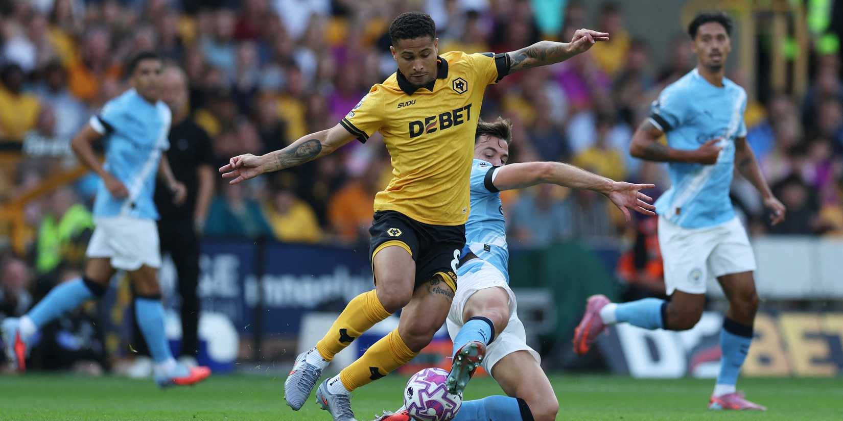 Wolverhampton Wanderers' Joao Gomes in action with Manchester City's Nico Gonzalez