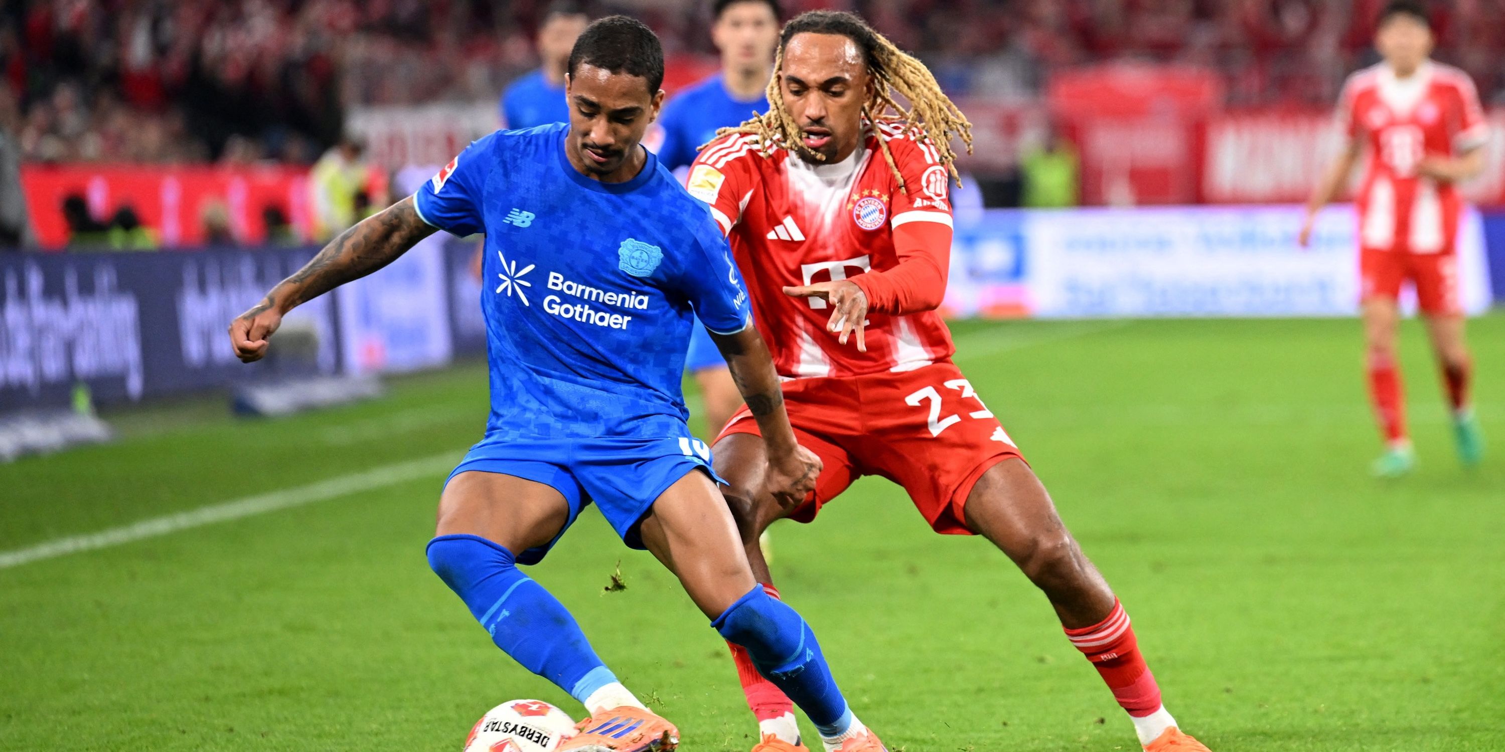 Bayer Leverkusen's Arthur in action with Bayern Munich's Sacha Boey