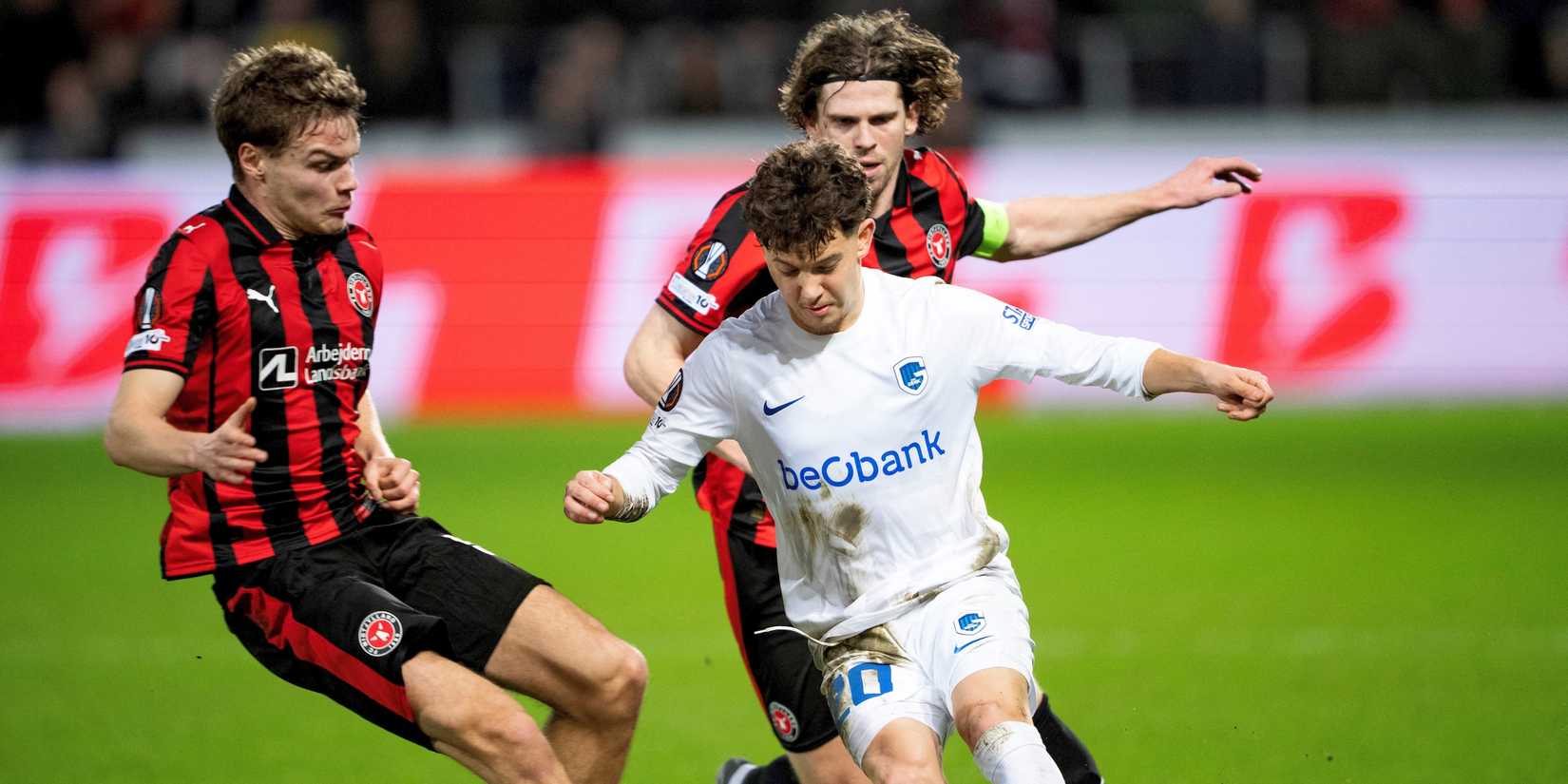 KRC Genk's Konstantinos Karetsas in action with FC Midtjylland's Viktor Bak and Mads Bech Bo Amstrup