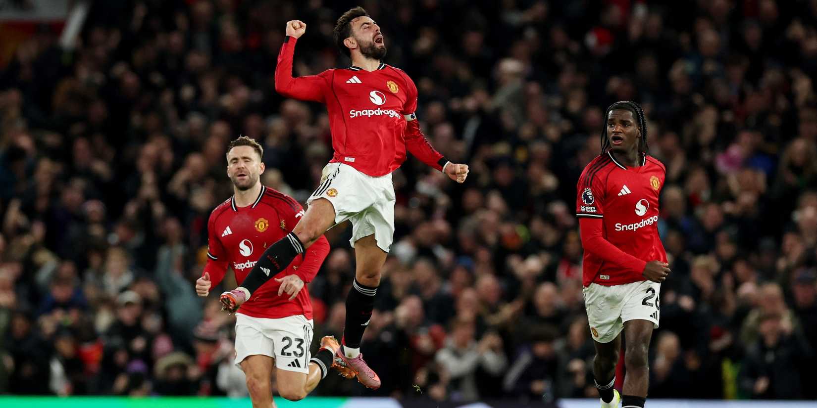    Manchester United's Bruno Fernandes celebrates their third goal with Manchester United's Luke Shaw and Manchester United's Eden Paradise