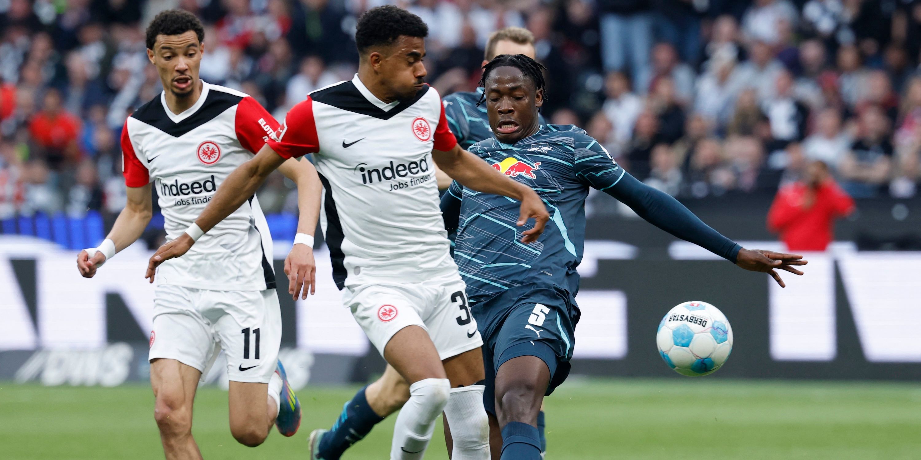 RB Leipzig's El Chadaille Bitshiabu fouls Eintracht Frankfurt's Ansgar Knauff