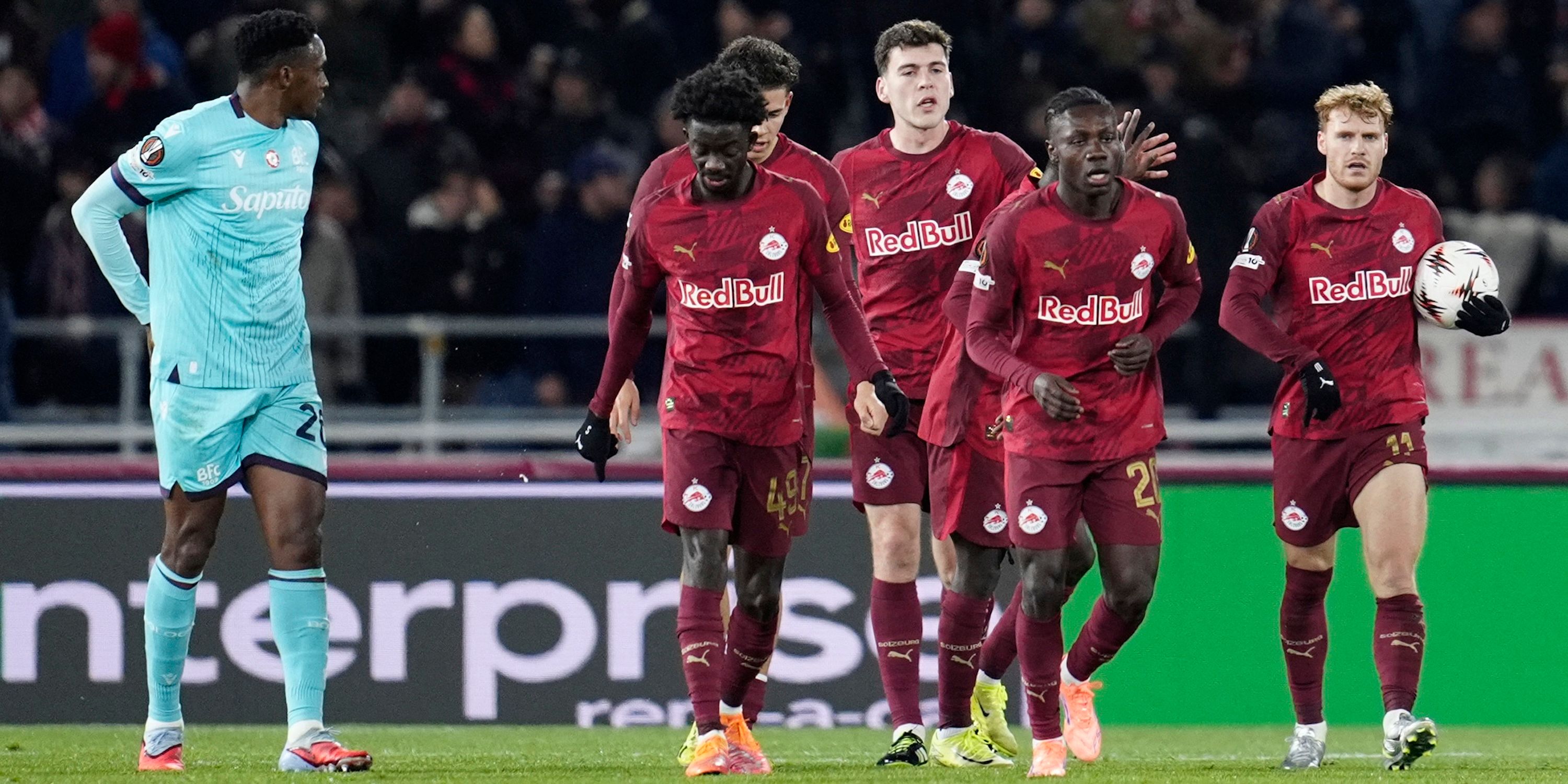 RB Salzburg's Yorbe Vertessen celebrates scoring their first goal with teammates as Bologna's Jhon Lucumi looks on