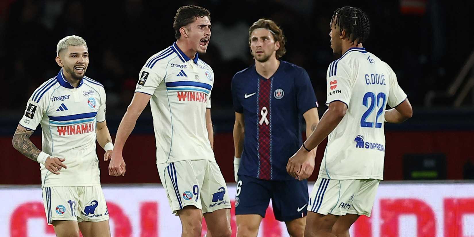 RC Strasbourg's Joaquin Panichelli celebrates scoring their first goal with RC Strasbourg's Julio Enciso and RC Strasbourg's Guela Doue