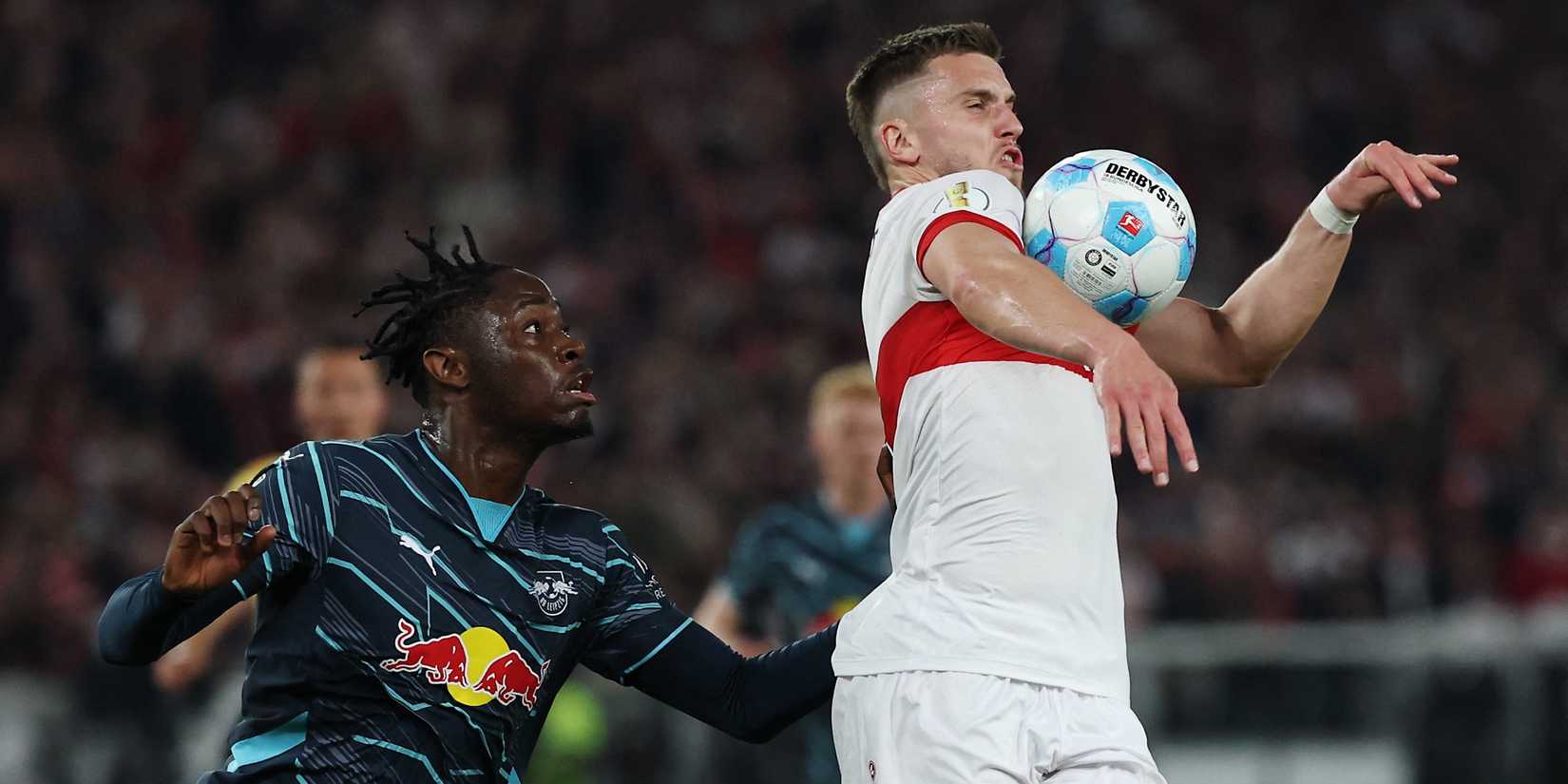 VfB Stuttgart's Ermedin Demirovic in action with RB Leipzig's El Chadaille Bitshiabu