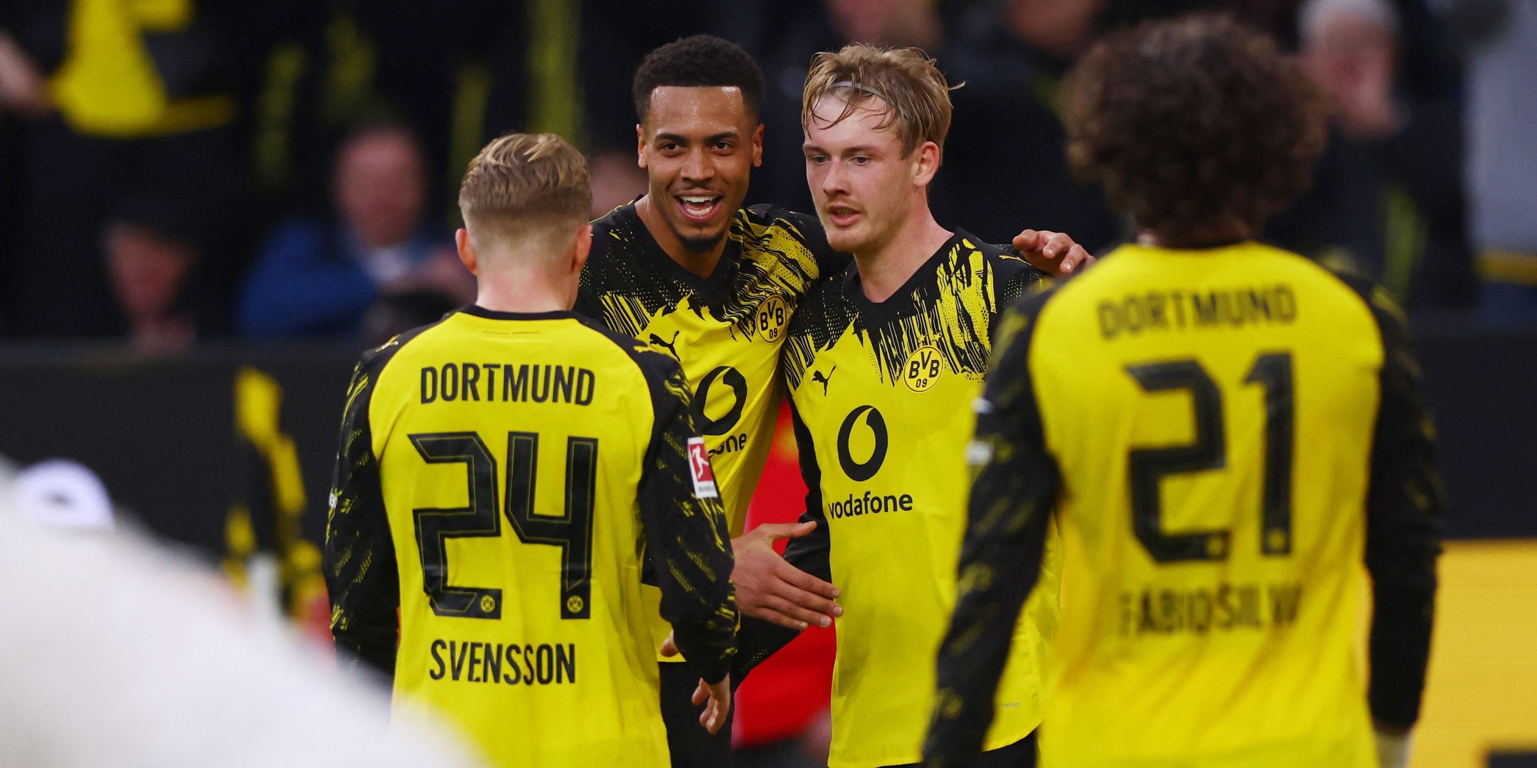 Borussia Dortmund's Julian Brandt celebrates scoring their first goal with Felix Nmecha and Daniel Svensson