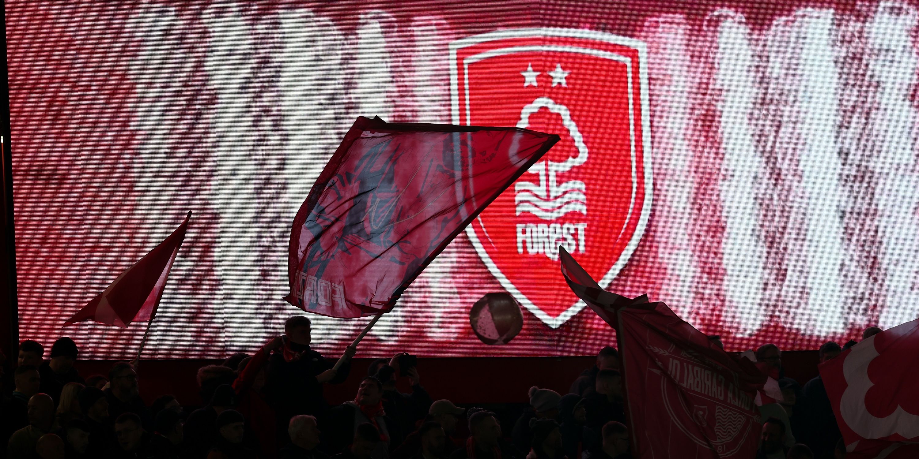 City Stadium panorama and Nottingham Forest flag waving in front of club crest