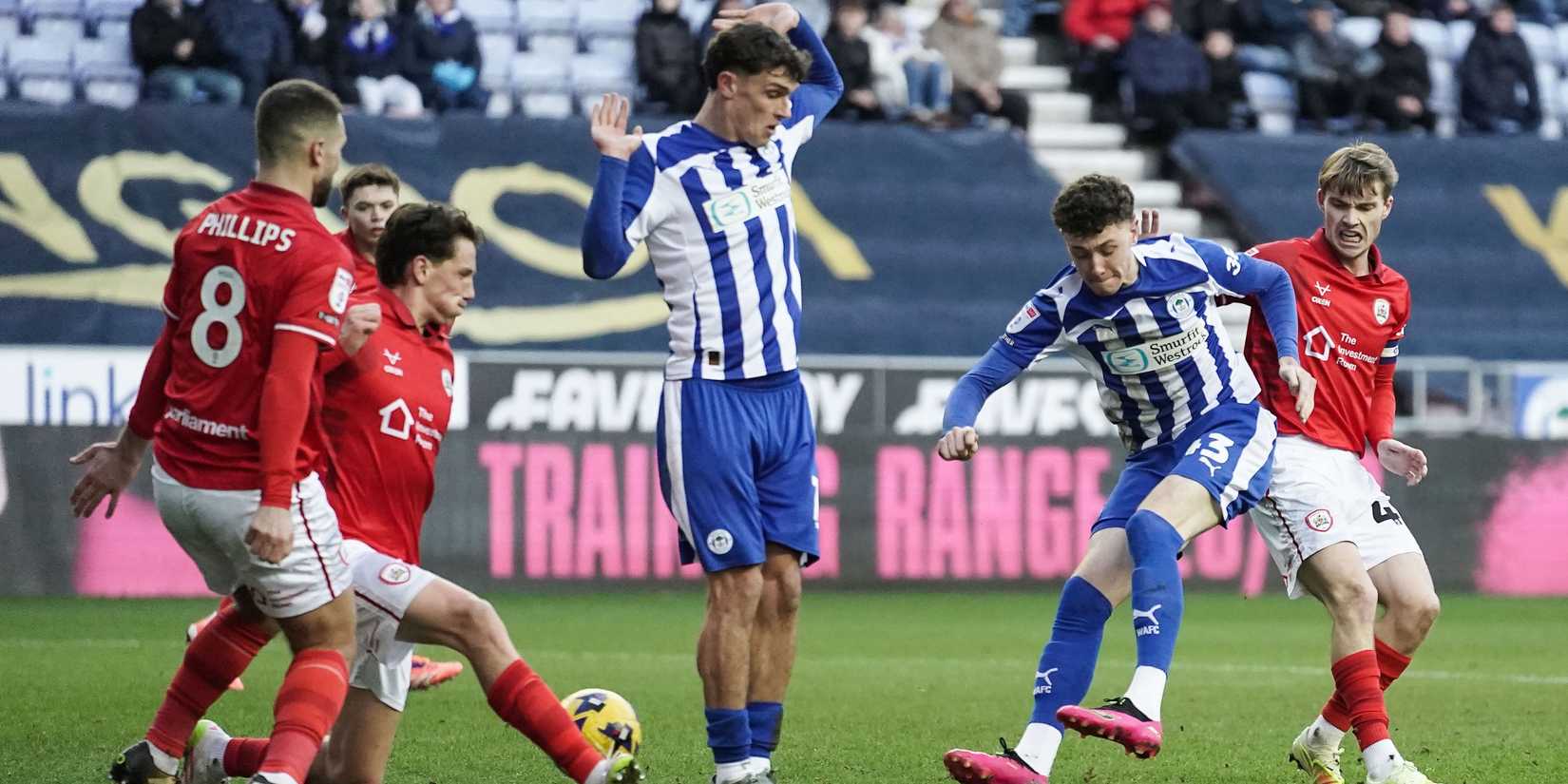 Harrison Bettoni of Wigan Athletic (second right) during the Sky Bet League 1 match at the Brick Community Stadium