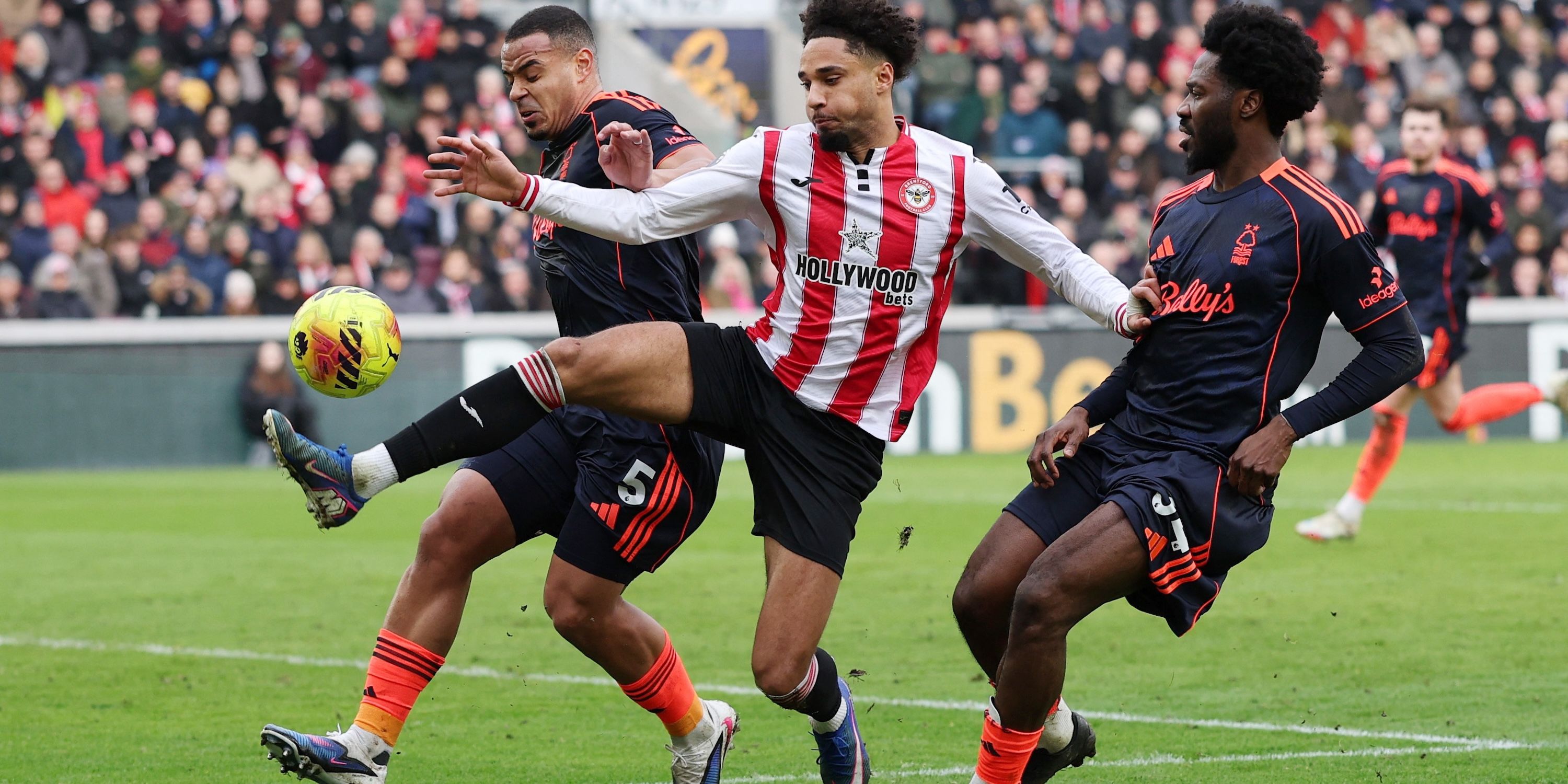 Brentford's Kevin Schade in action with Nottingham Forest's Murillo and Ola Aina